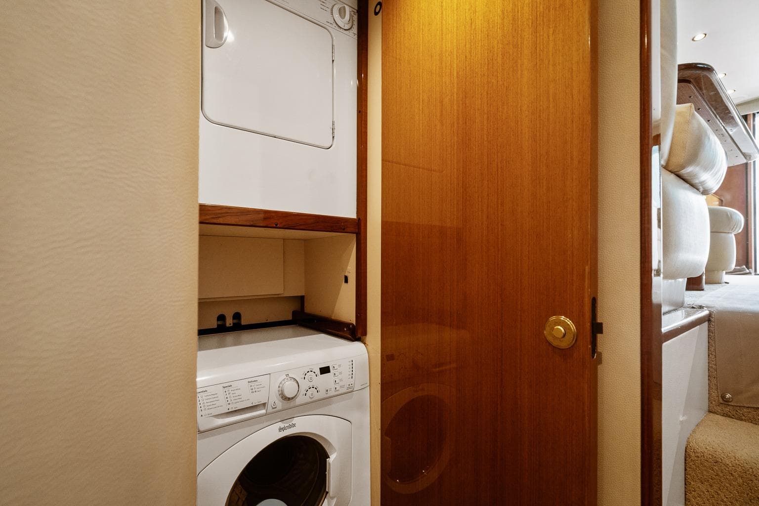 Laundry area in 2002 Viking 61 Convertible yacht with stacked washer and dryer.