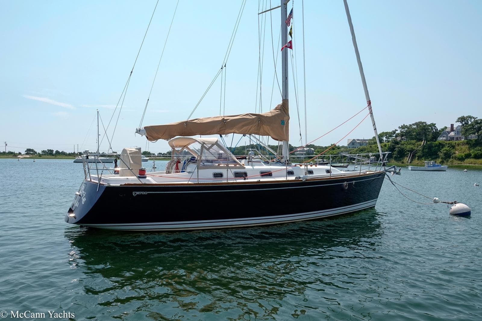 Sailboat Tartan 3700, 2002 model, anchored in calm waters under a clear sky.