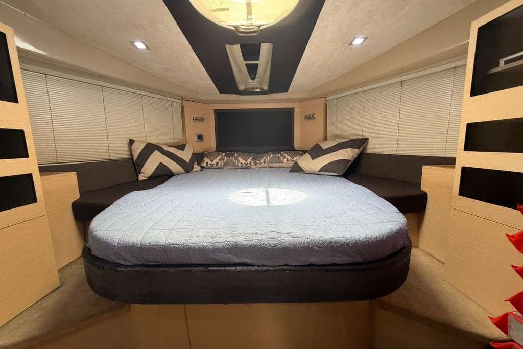 Luxurious cabin interior of 2013 Cranchi Endurance 41 yacht with cozy bedding and modern design.