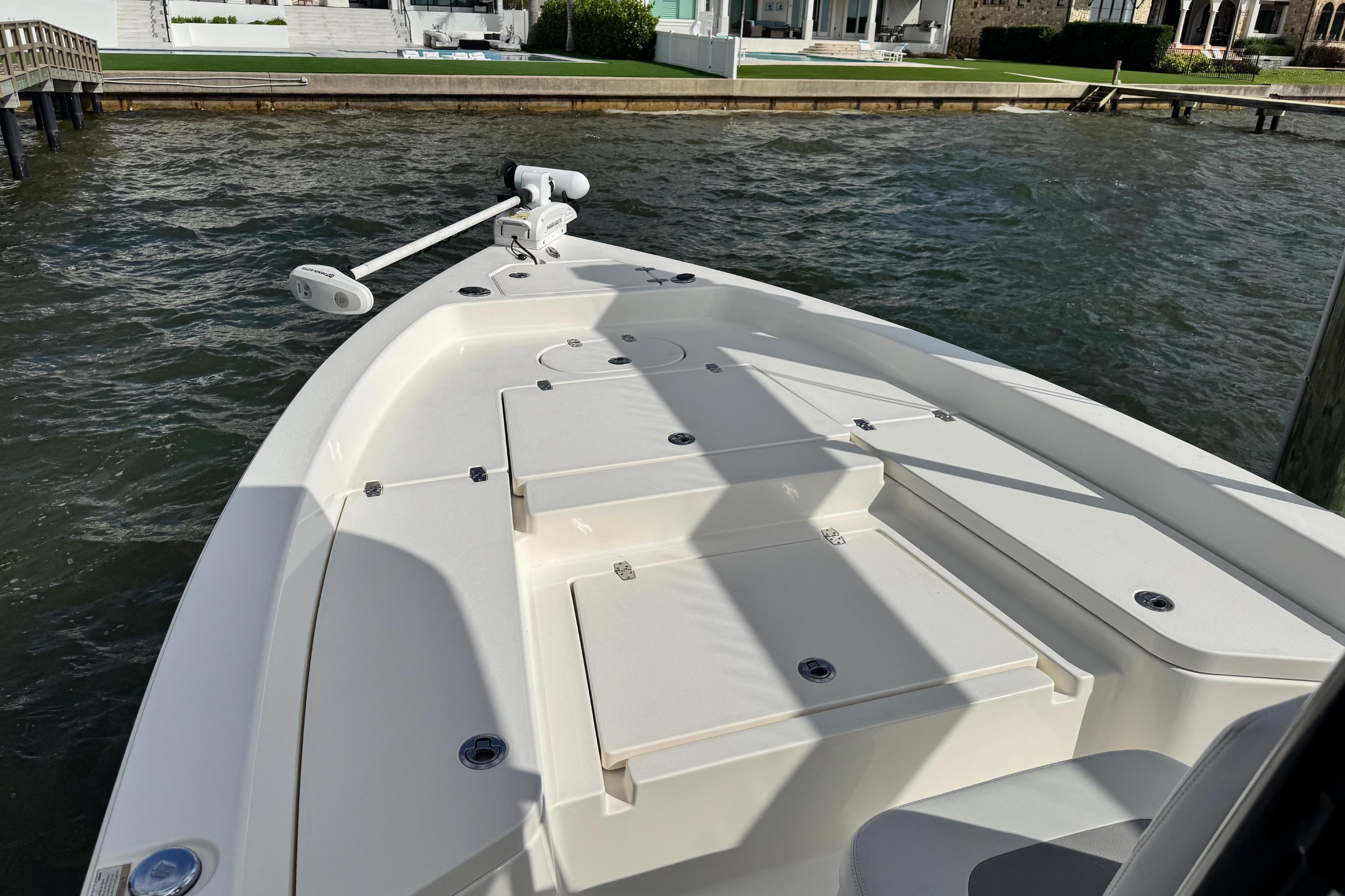 2022 Pathfinder 2400 TRS boat docked by waterfront homes.