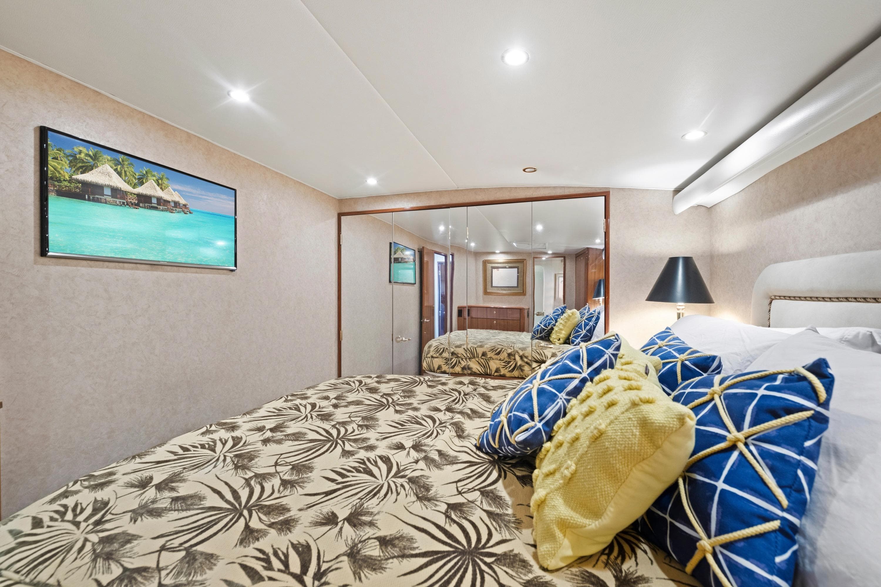 Luxurious bedroom interior in a 2005 Viking Convertible yacht, featuring elegant decor and plush bedding.