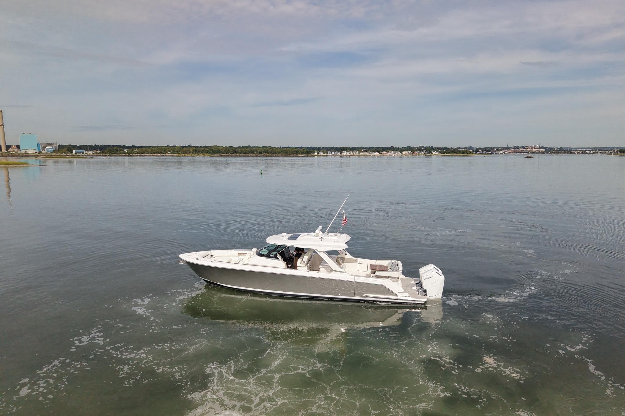 2025 Tiara Yachts 43 LS cruising on calm waters under a clear sky.