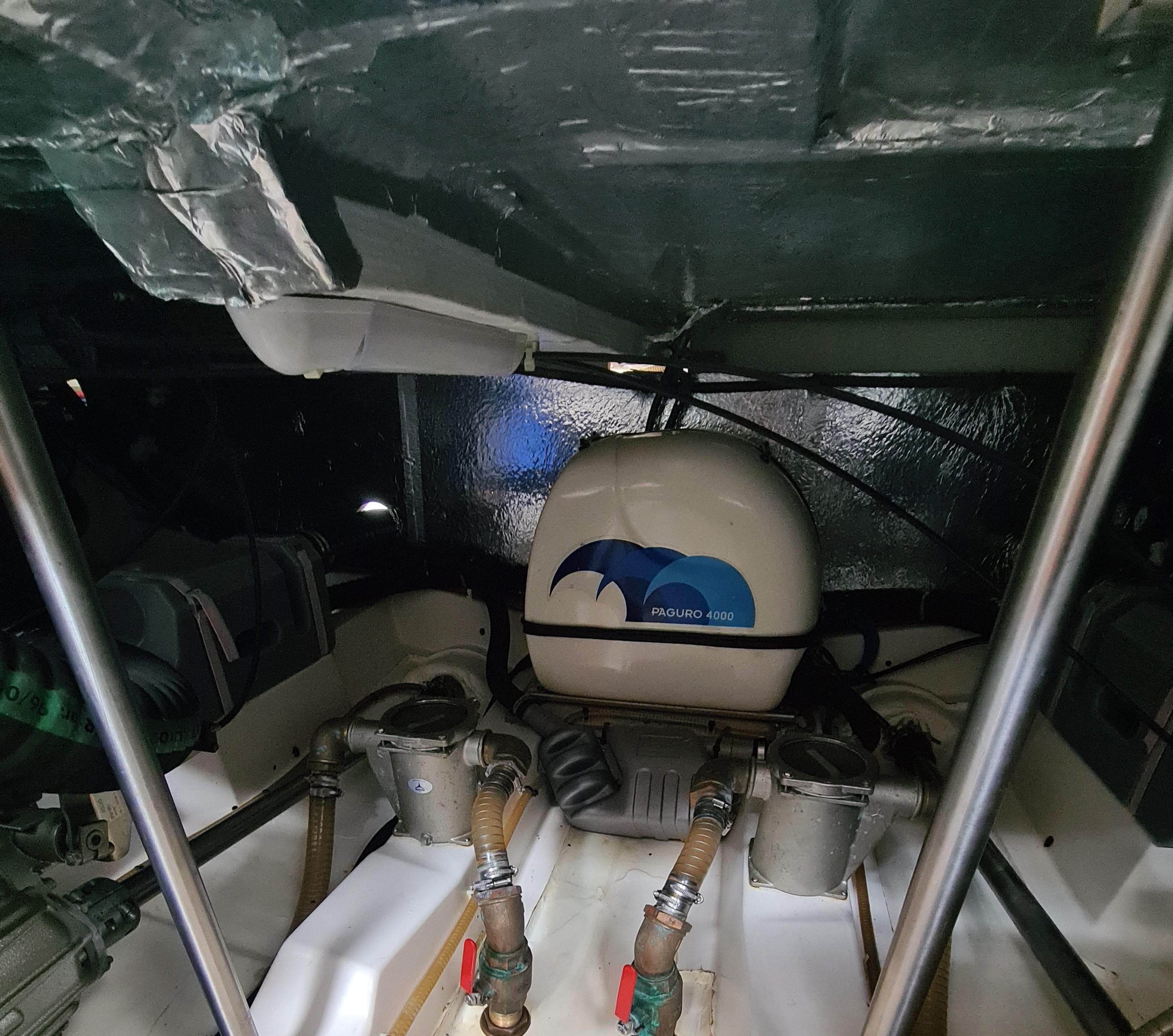 Engine room of a 2013 Greenline 40 boat, featuring mechanical components and wiring.