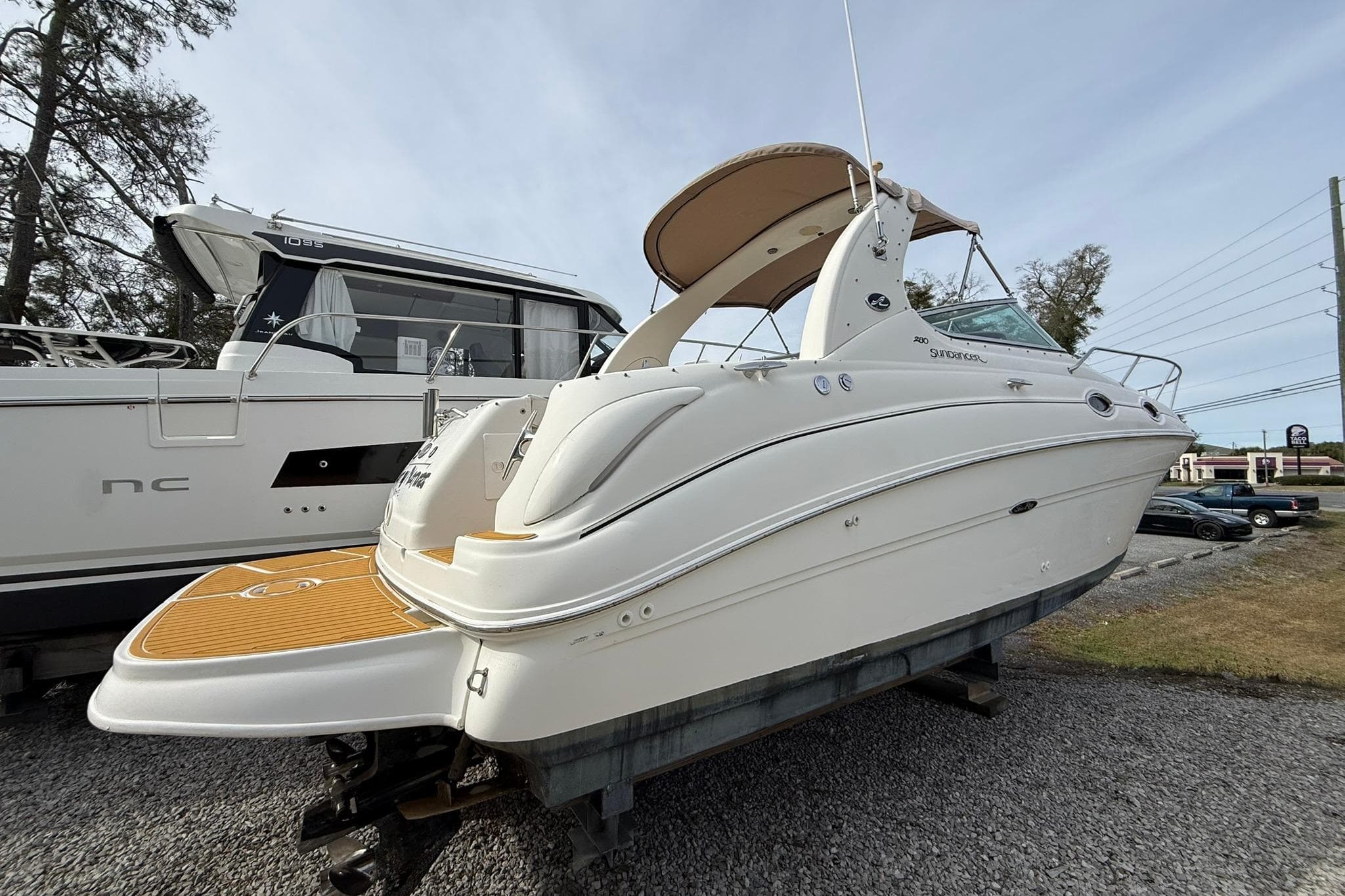 2001 Sea Ray 280 Sundancer boat on display, side view with sleek design.