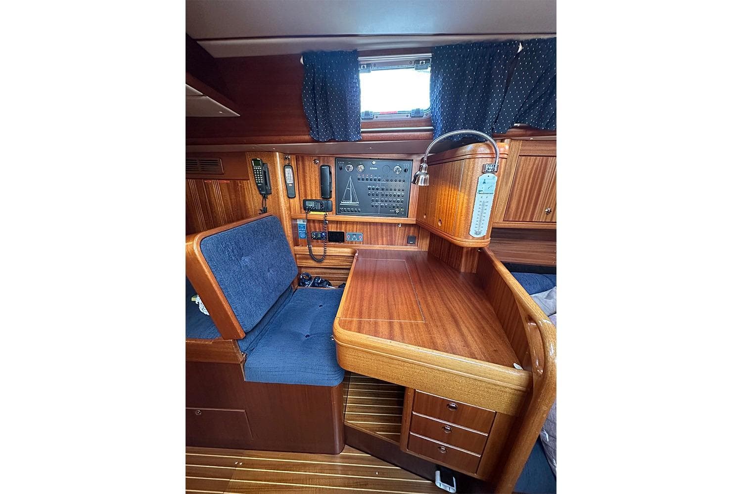 Interior of 2004 Najad 460 yacht with navigation station and wooden finish.