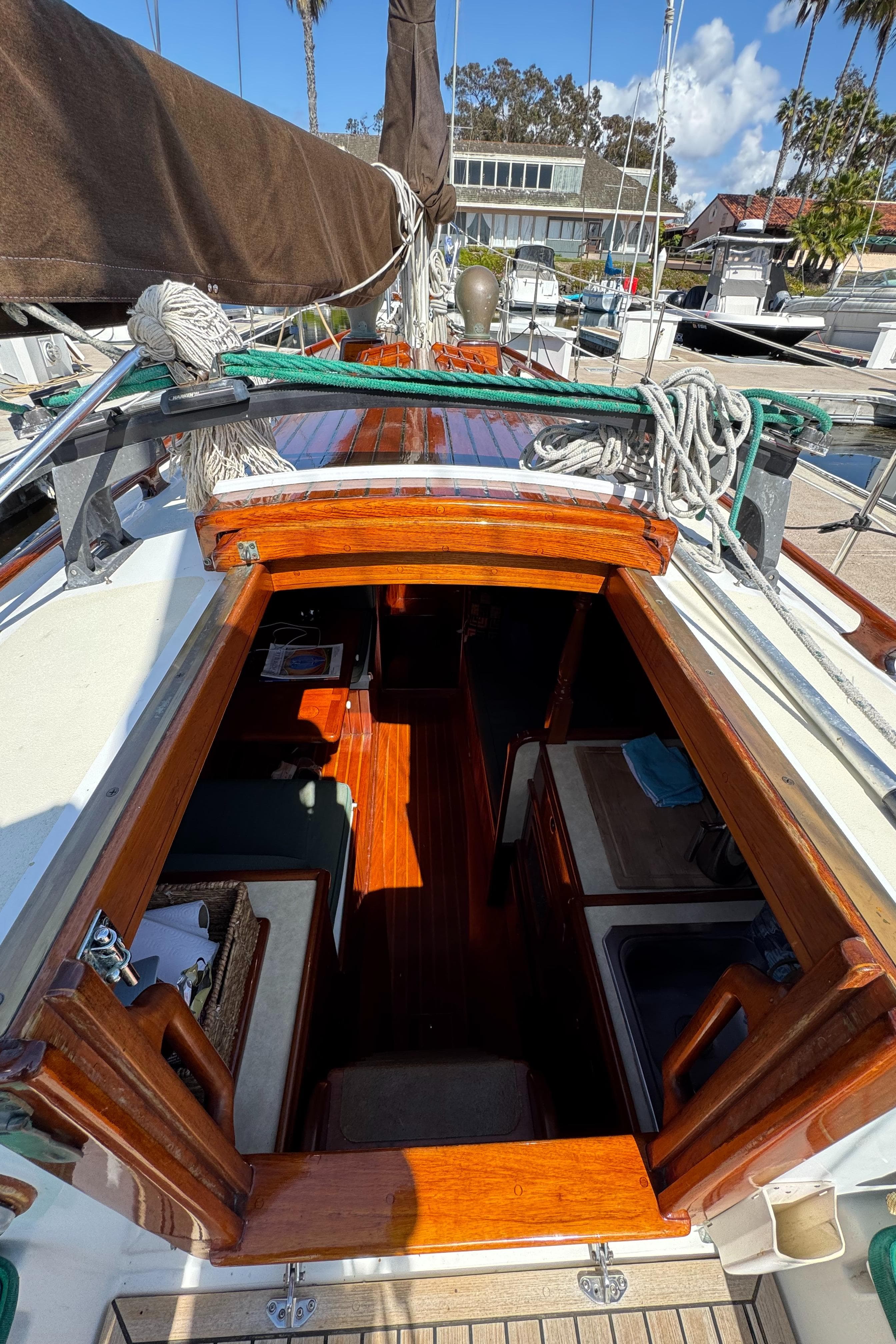 1988 Custom Aft Cockpit sailboat interior with wooden finish, docked at marina.