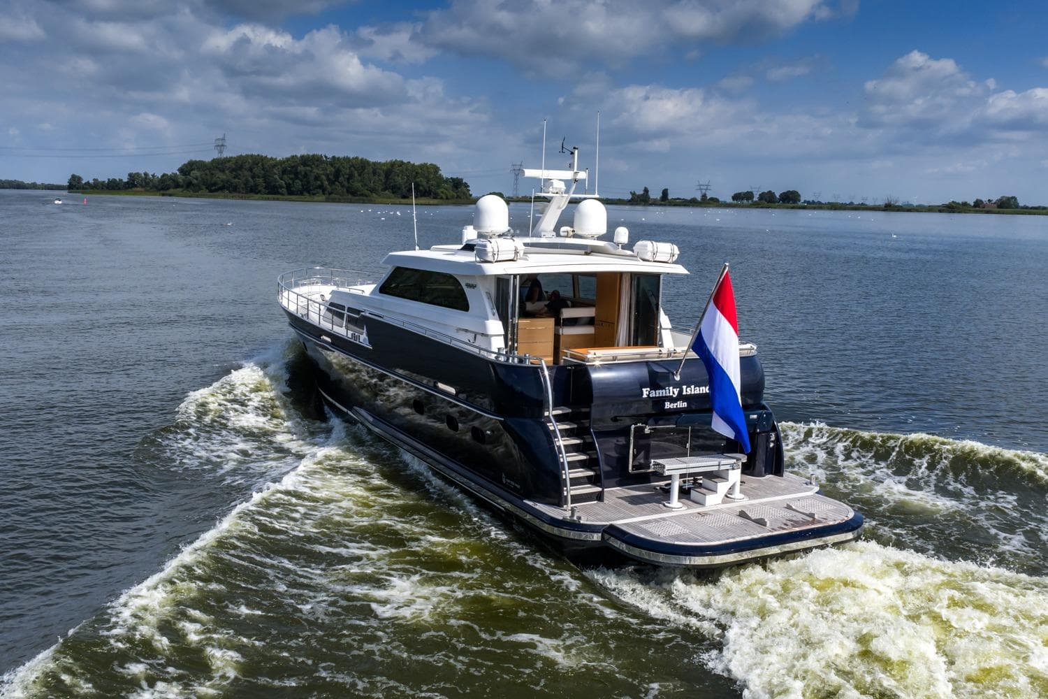 Luxurious 2013 Valk Continental 2000 Aluminium yacht cruising on a serene waterway.