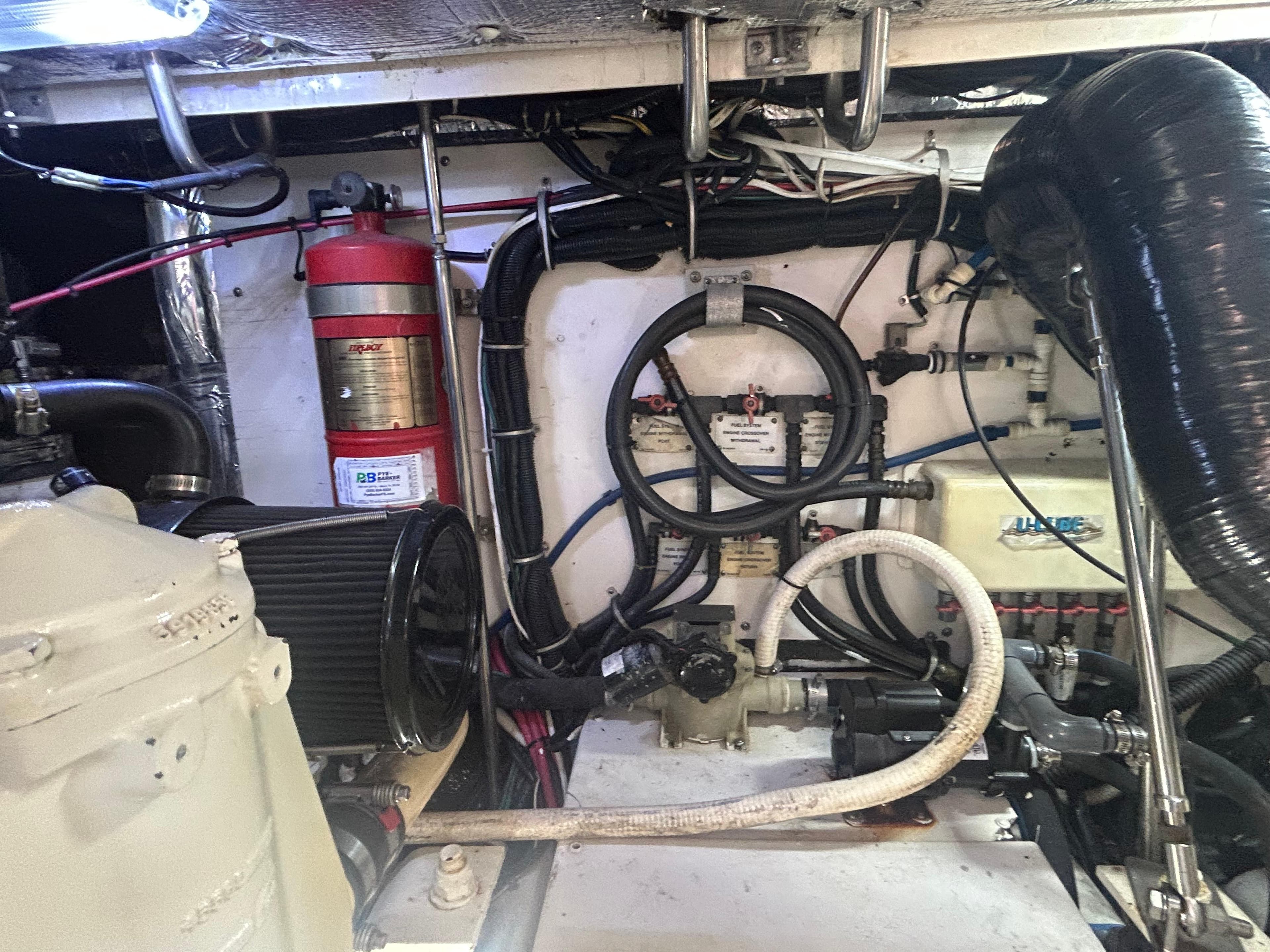 Engine room of a 1998 Tiara Yachts 3500 Express, showcasing mechanical components and wiring.