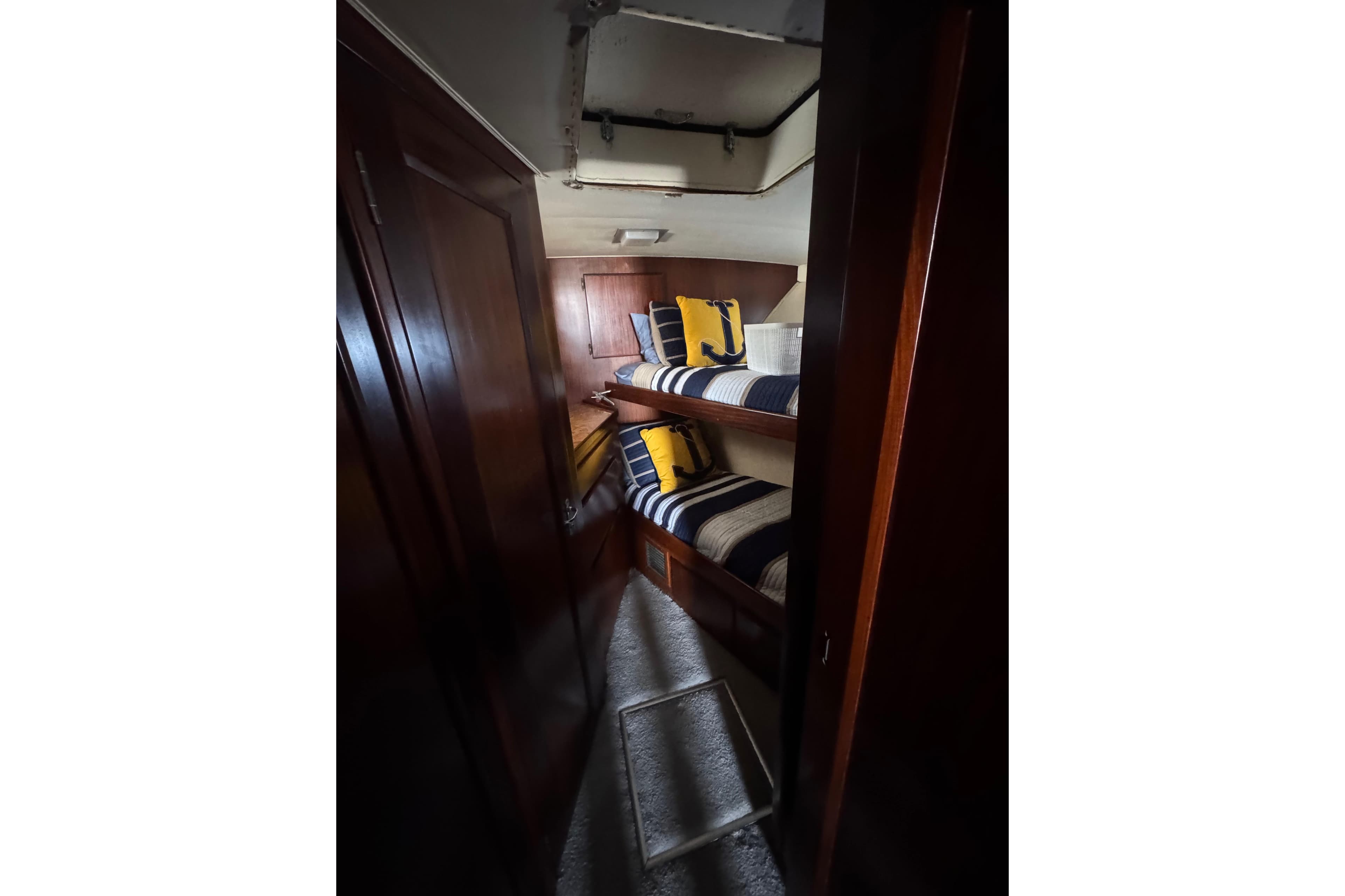 Interior cabin of 1990 Hatteras 52 Convertible yacht with bunk beds and nautical decor.