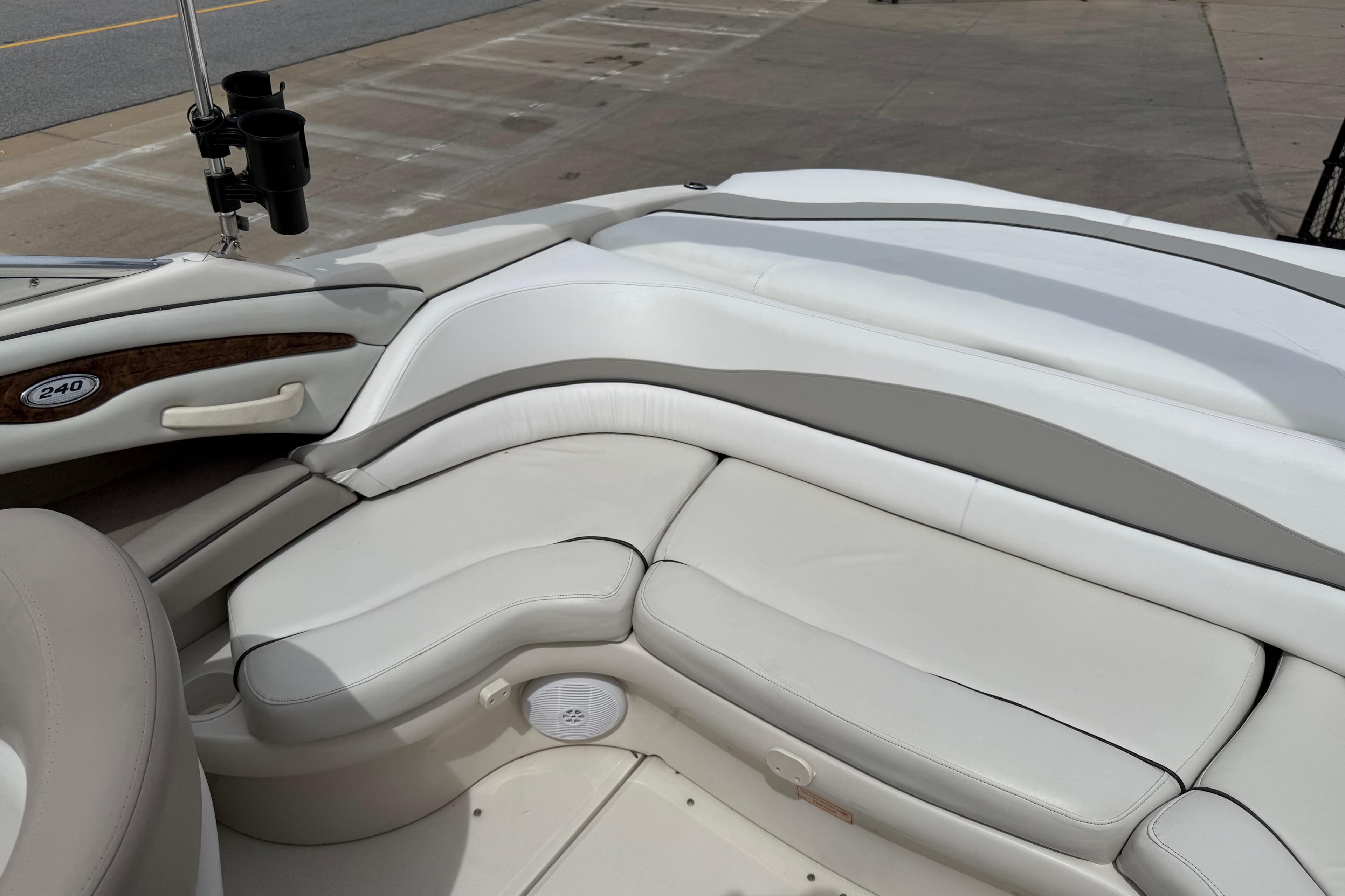2003 Sea Ray 240 Bow Rider interior with white leather seating and cup holders.