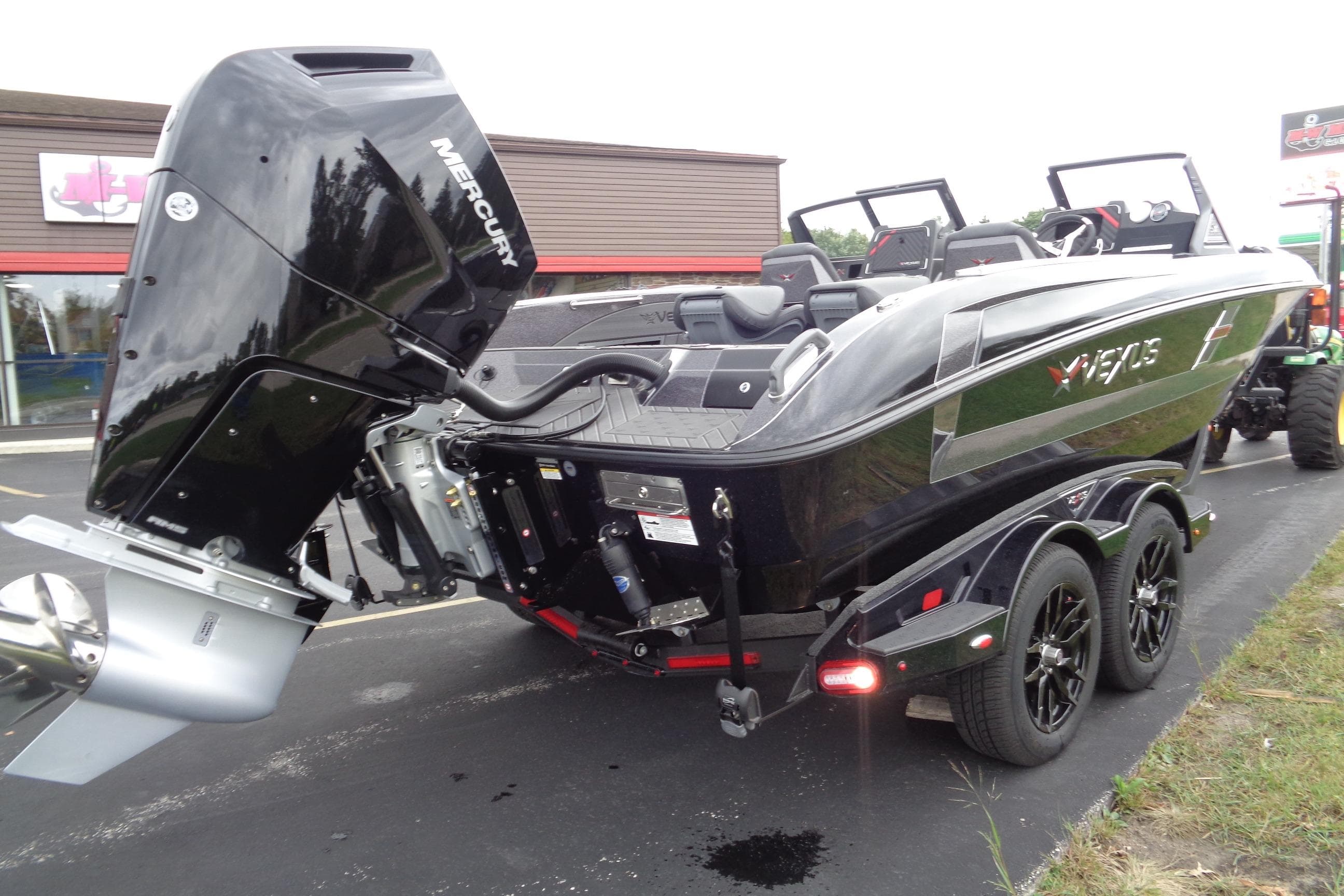 2026 Vexus DVX22S boat with Mercury engine on a trailer, parked outdoors.