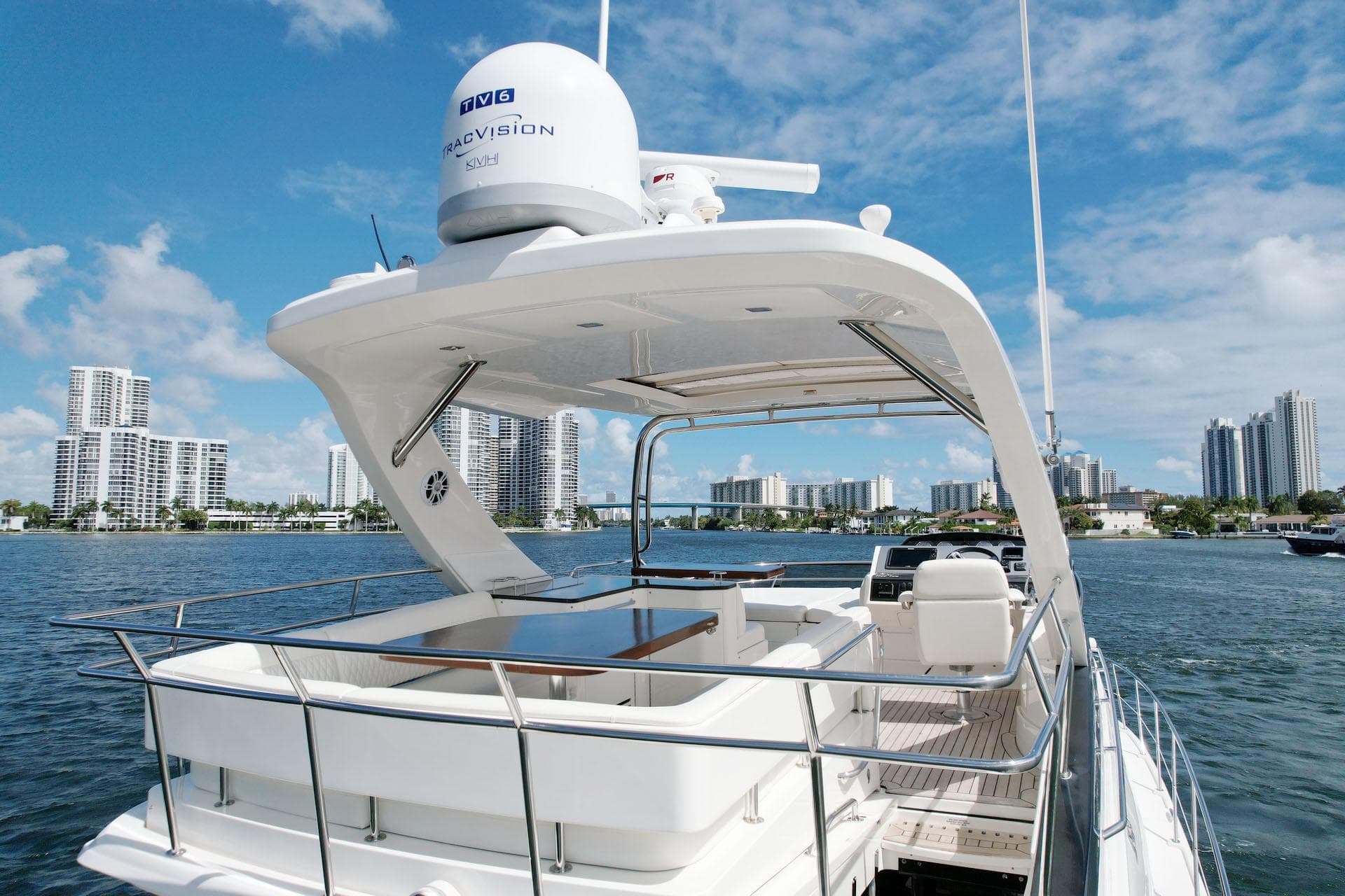 2015 Sea Ray 510 Fly yacht on water with city skyline in background.