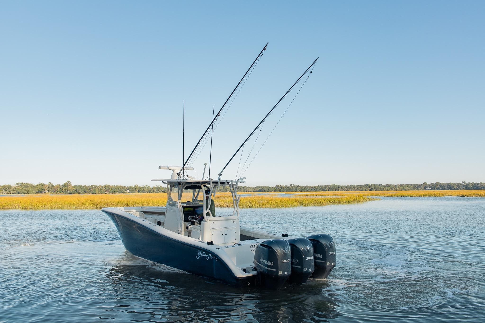2014 Yellowfin 34 Offshore boat with triple Yamaha engines on calm water.
