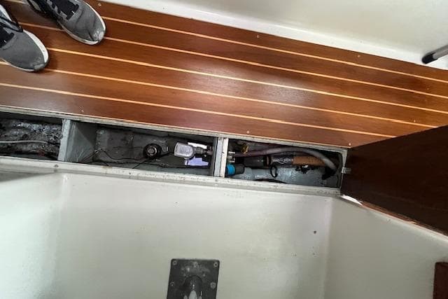 1981 Niagara 31 boat interior showing wooden flooring and exposed mechanical components.