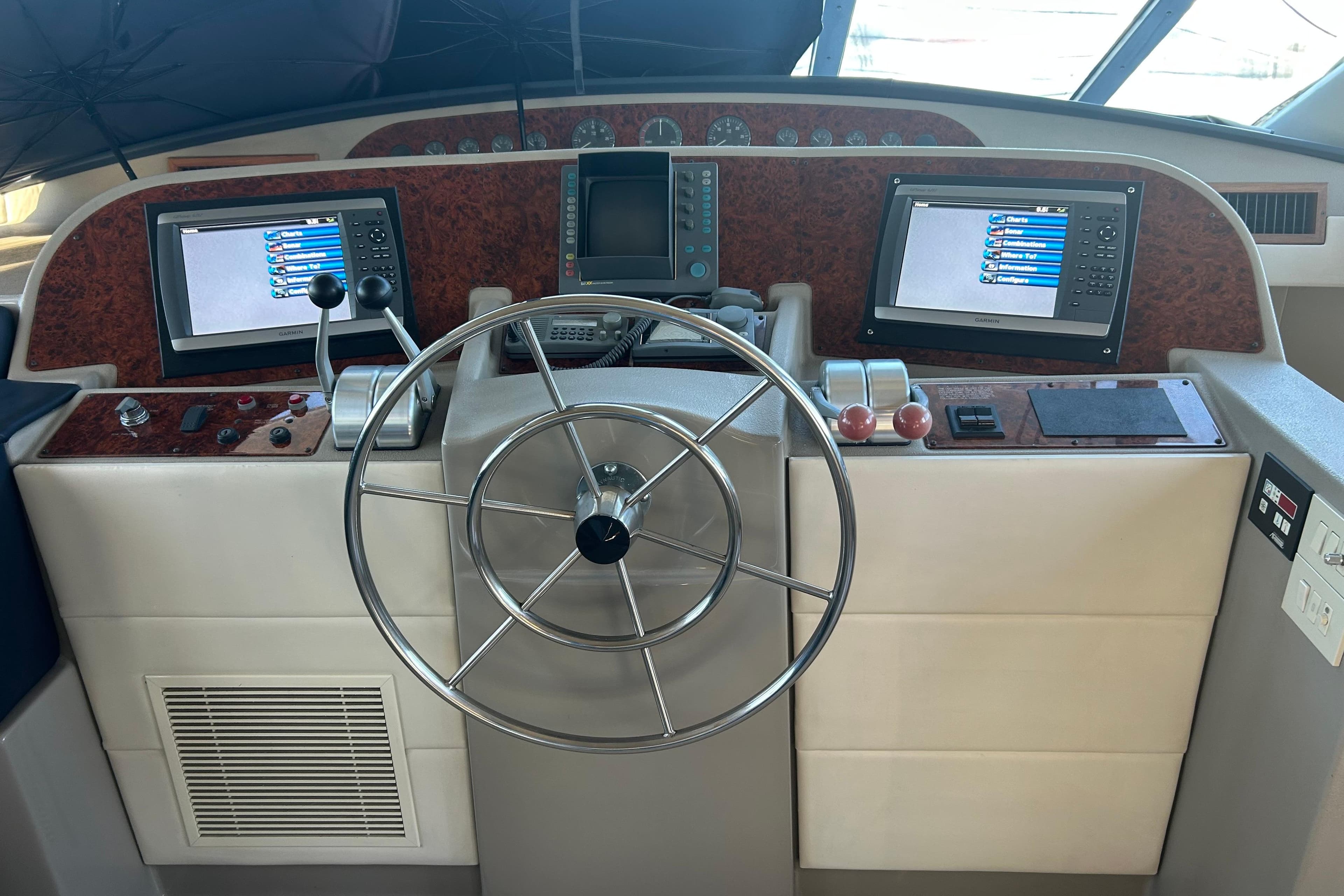 1998 Bayliner 5788 Pilot House Motoryacht helm with dual screens and steering wheel.