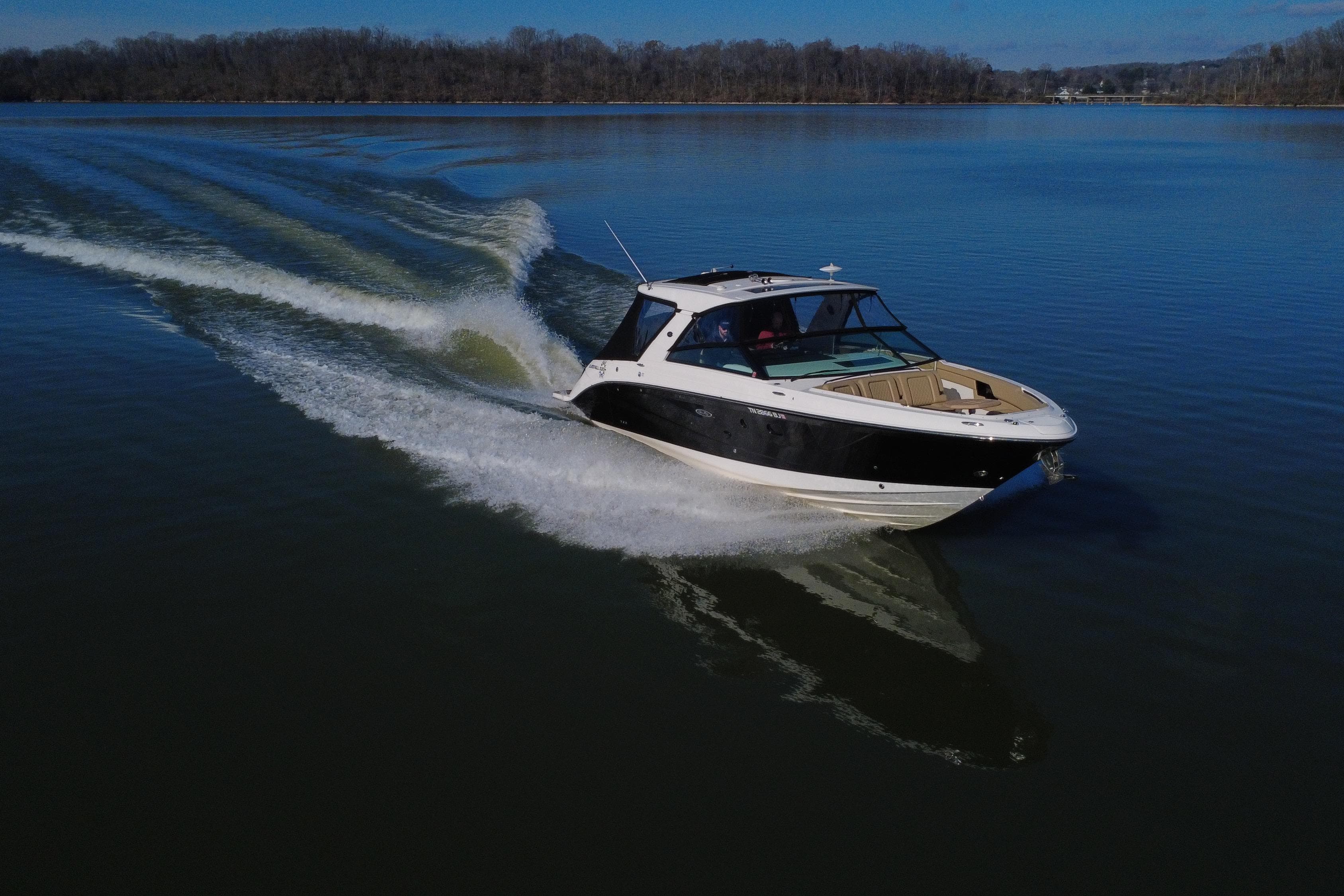2022 Sea Ray SLX 400 cruising on a calm lake, creating a smooth wake.