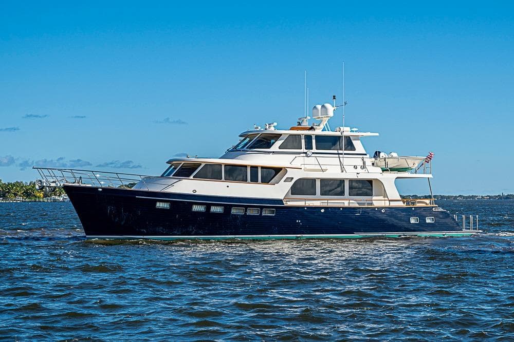 2014 Marlow Explorer 66E yacht cruising on open water under clear blue sky.