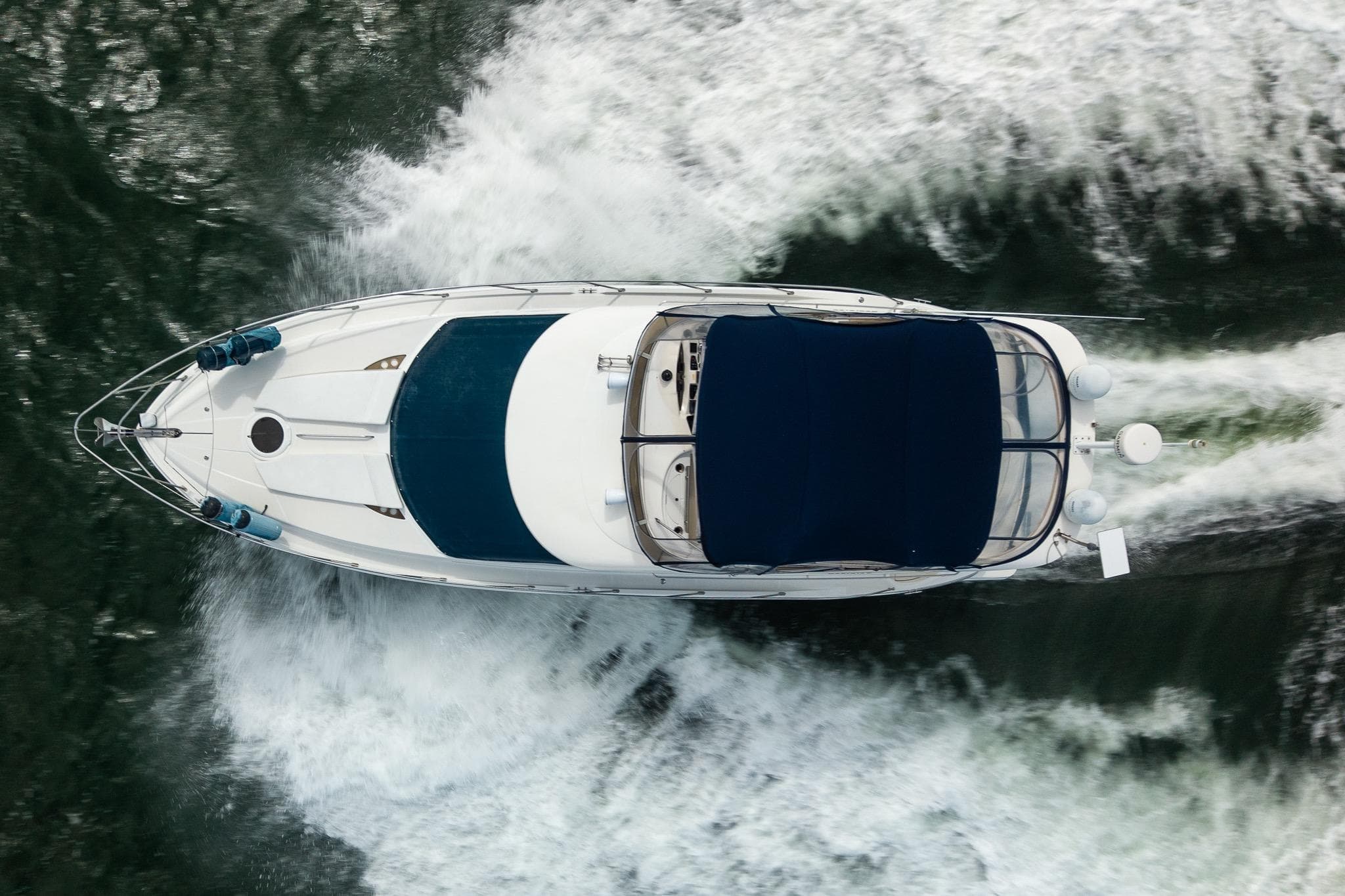 Aerial view of 2009 Meridian 391 Sedan yacht cruising on water.