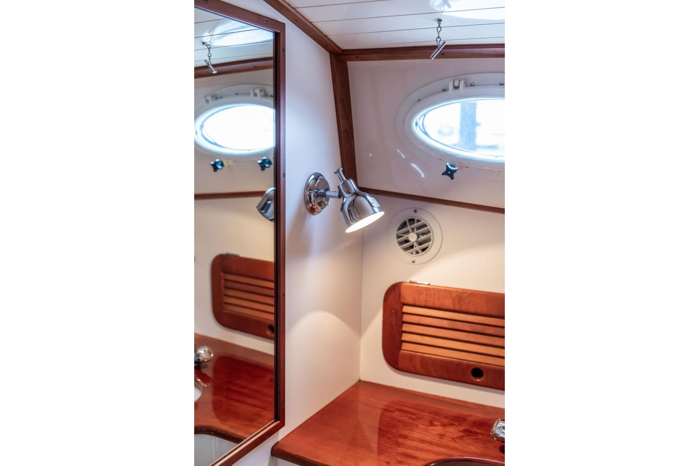 2004 Hinckley Picnic Boat EP interior with wooden accents and porthole window.