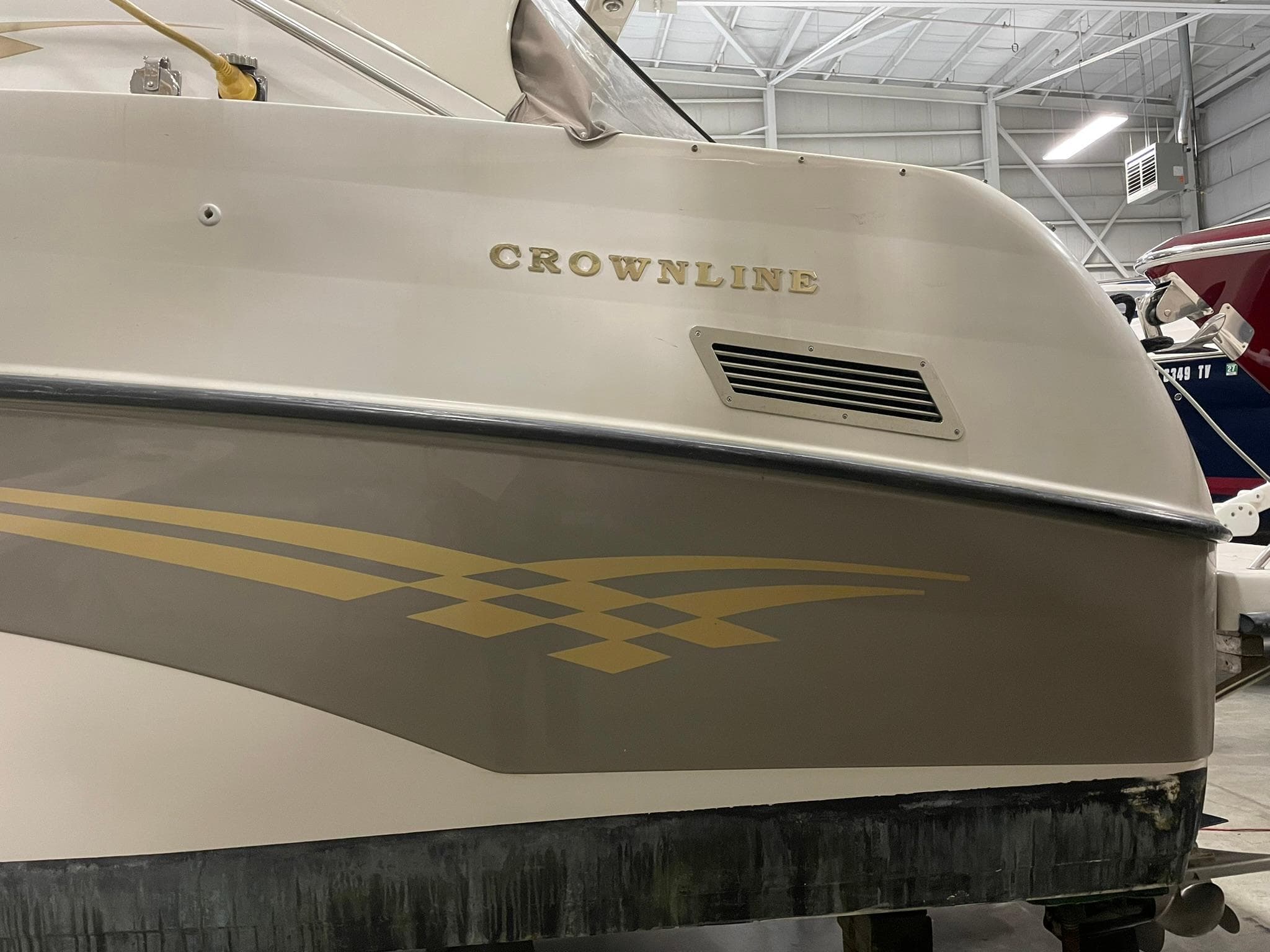 Crownline 290 CR 2000 boat in storage, showcasing sleek design and branding.