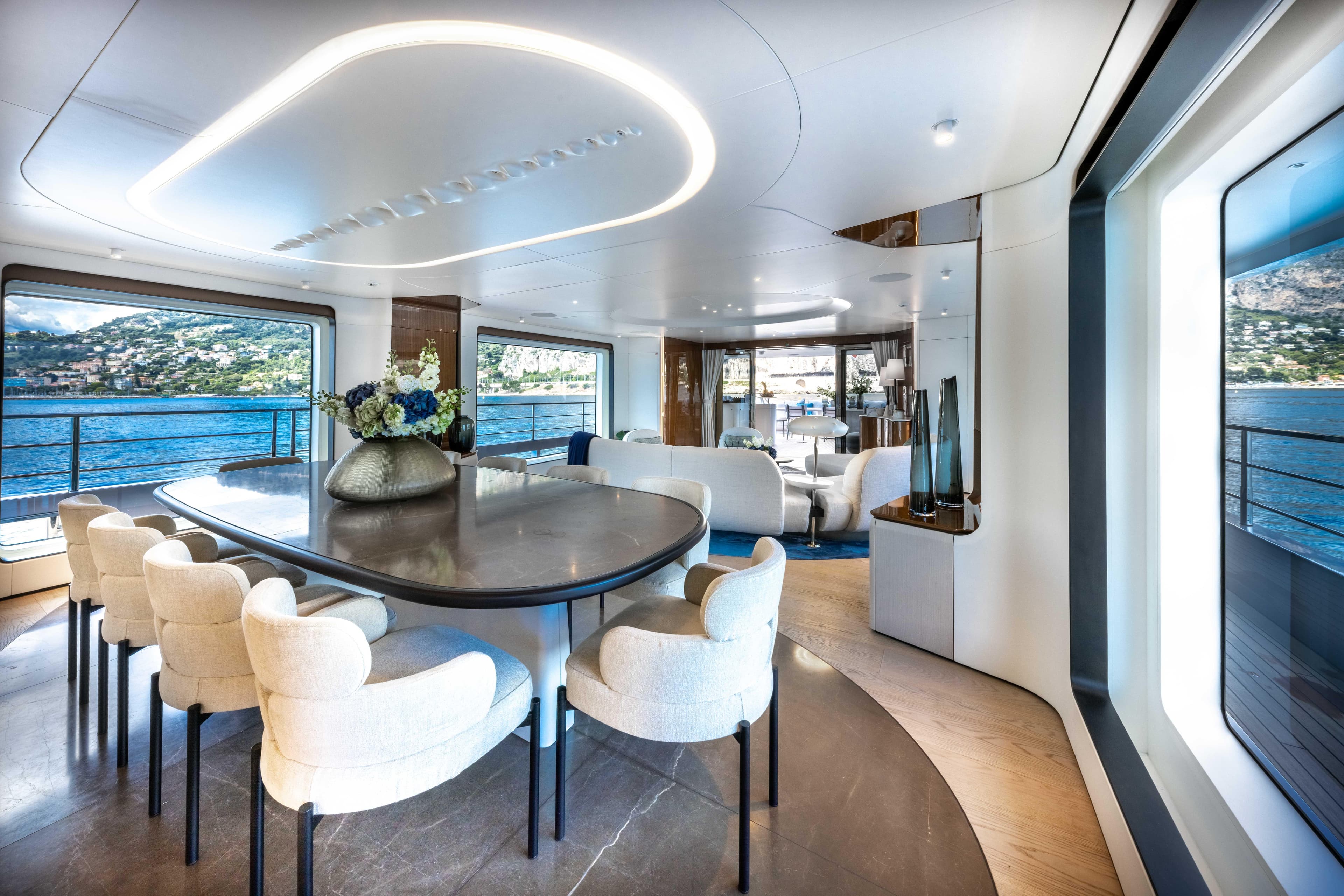 Luxurious interior of 2022 Azimut Grande 36M yacht with elegant dining area and scenic ocean views.