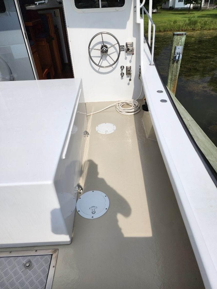 2016 Custom Broad Creek 32 Downeast boat deck with steering wheel and clean layout.