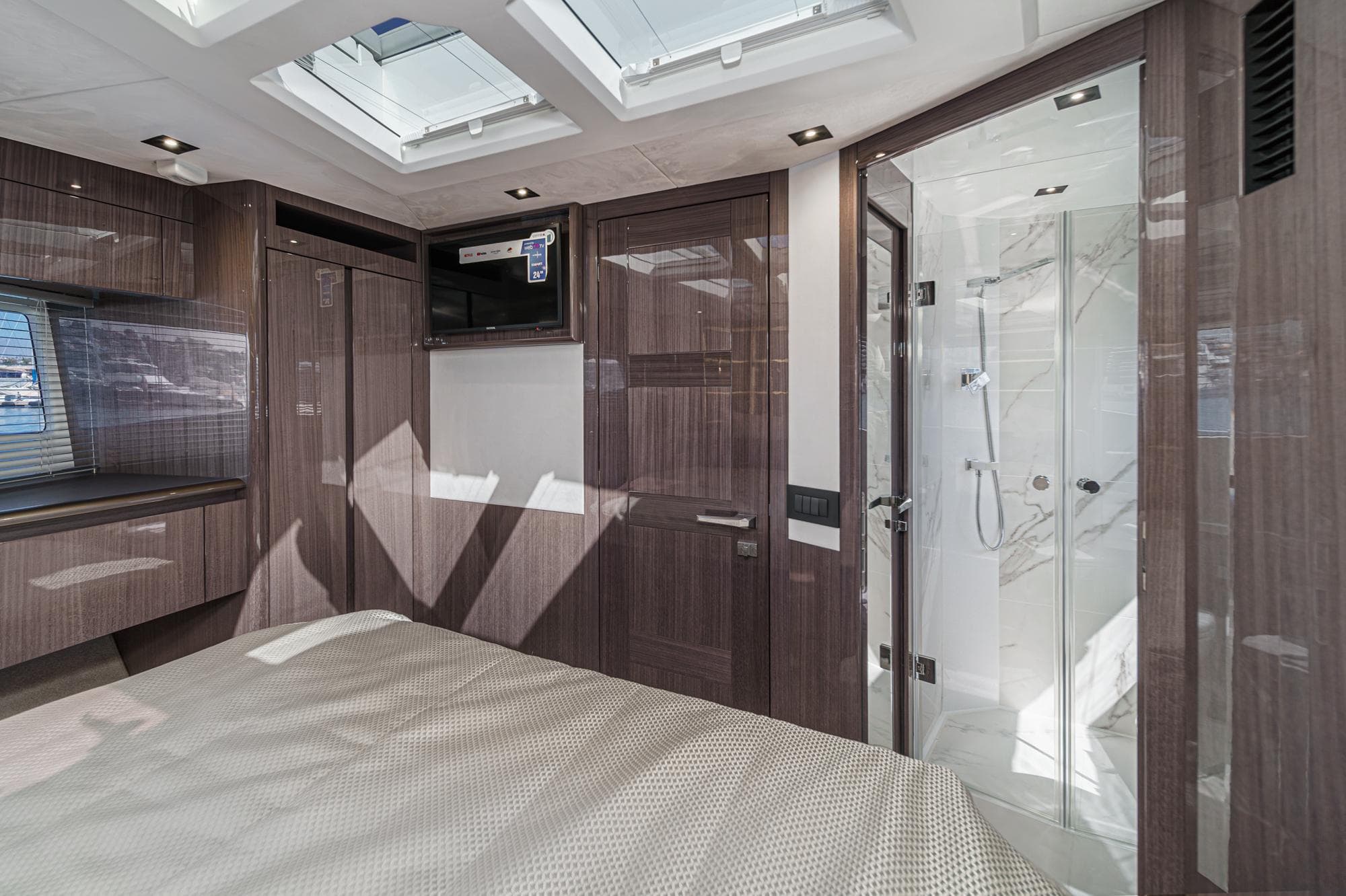 Luxurious interior of 2025 Galeon 500 Fly yacht with modern wood finishes and skylights.