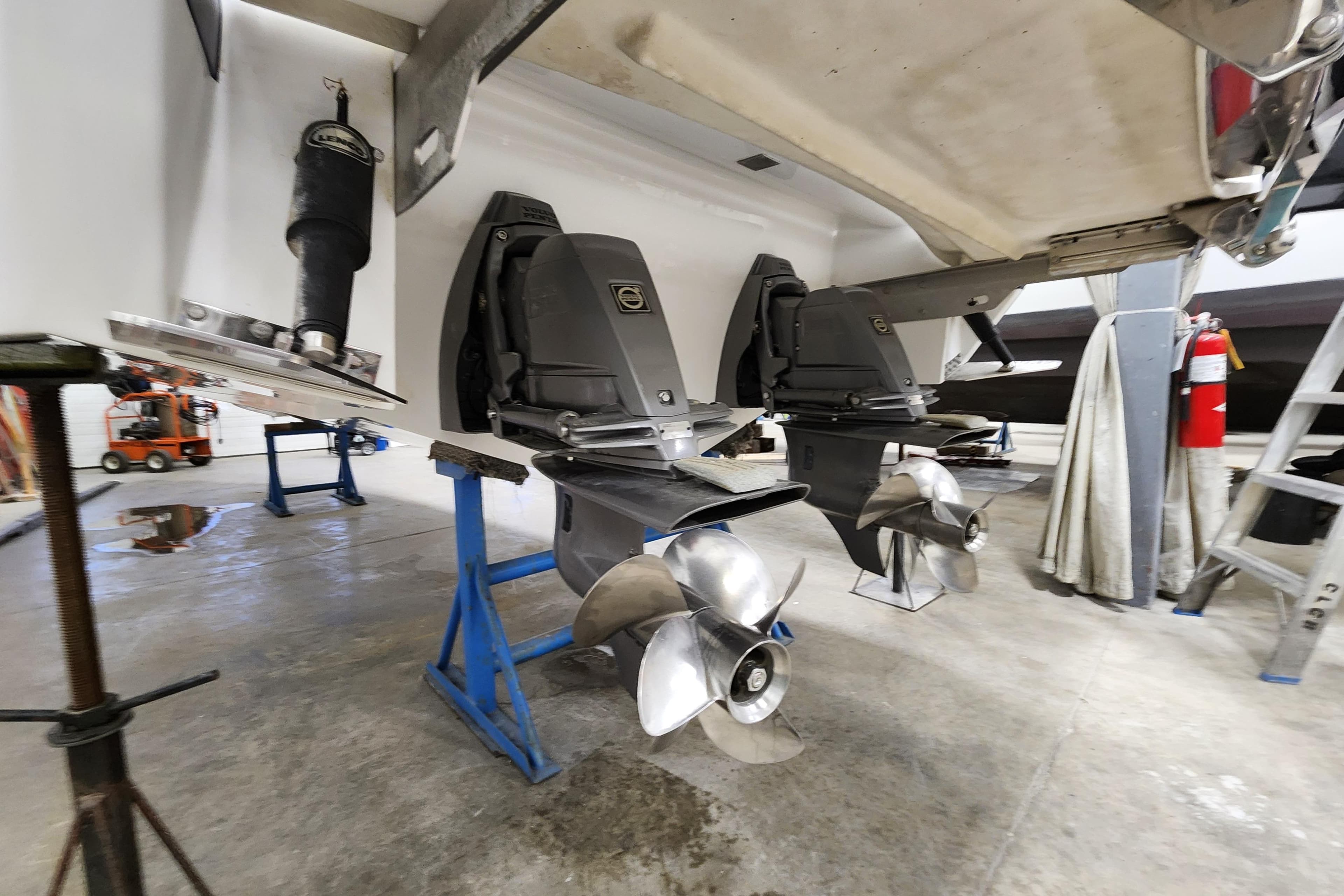 2012 Cobalt 296 boat propellers and outdrives in a maintenance facility.
