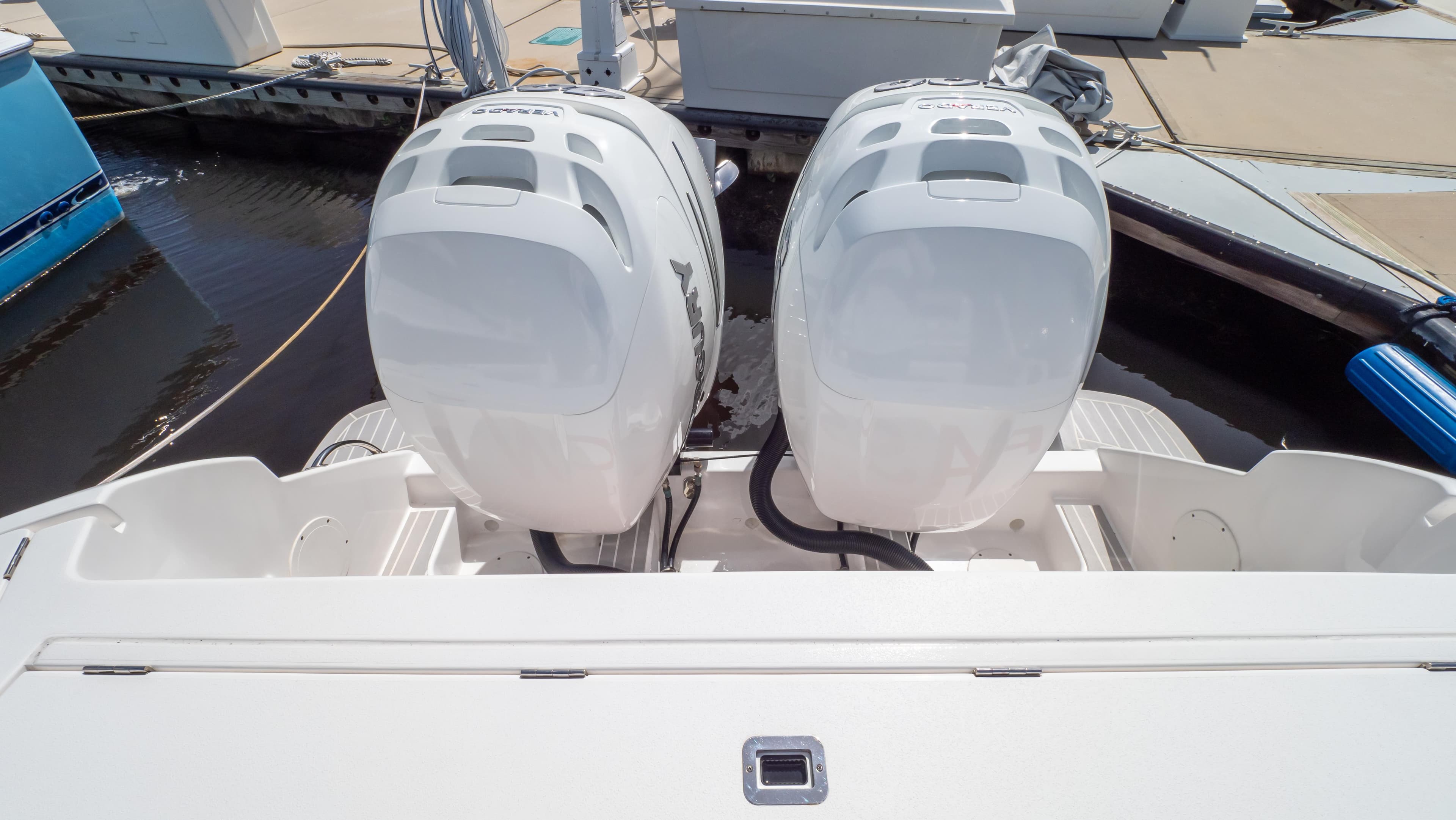 Twin outboard engines on a 2022 Intrepid 345 Valor boat at a dock.