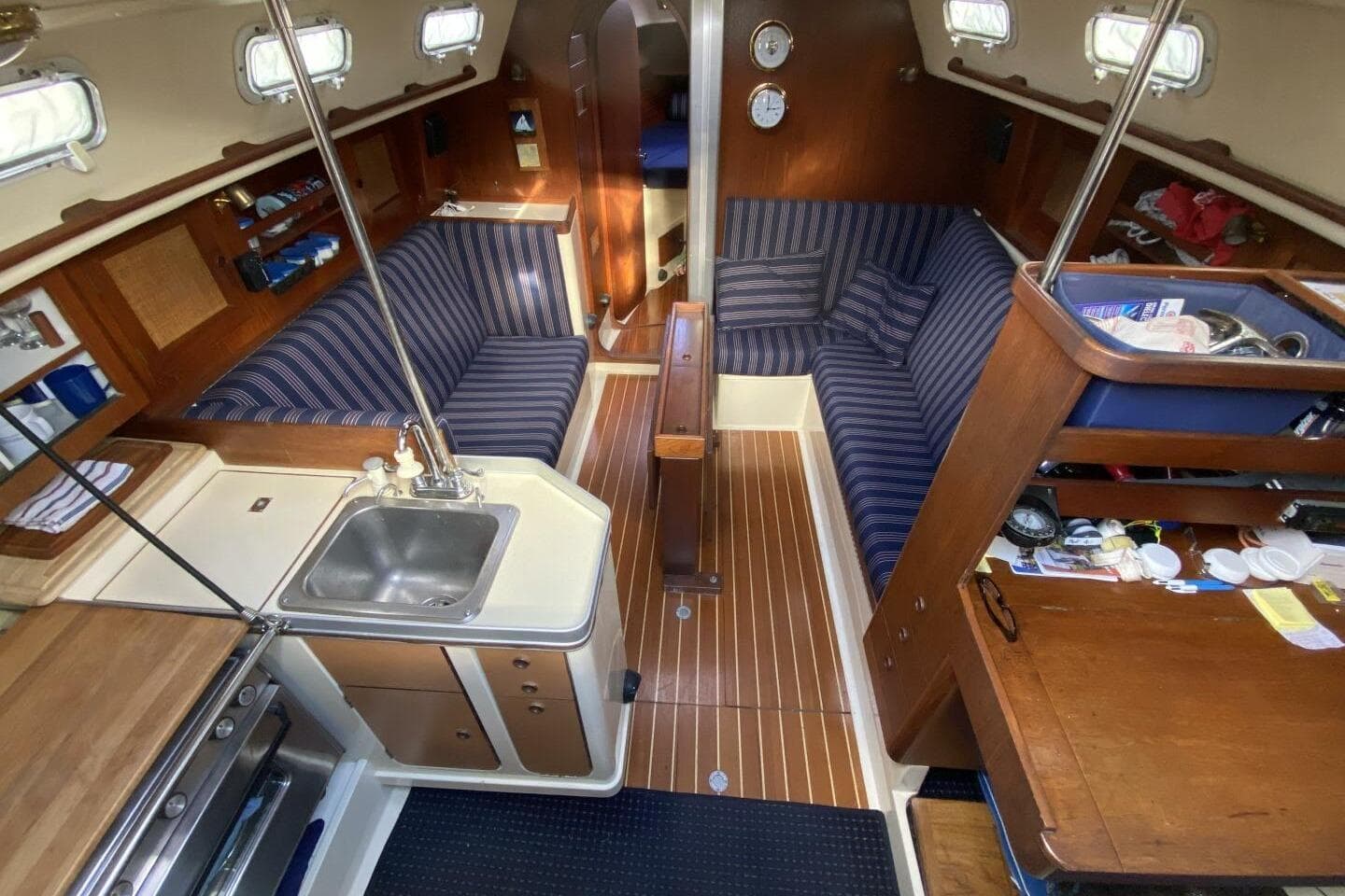 Interior of 1980 CS 36 Traditional sailboat with cozy seating and compact kitchen area.