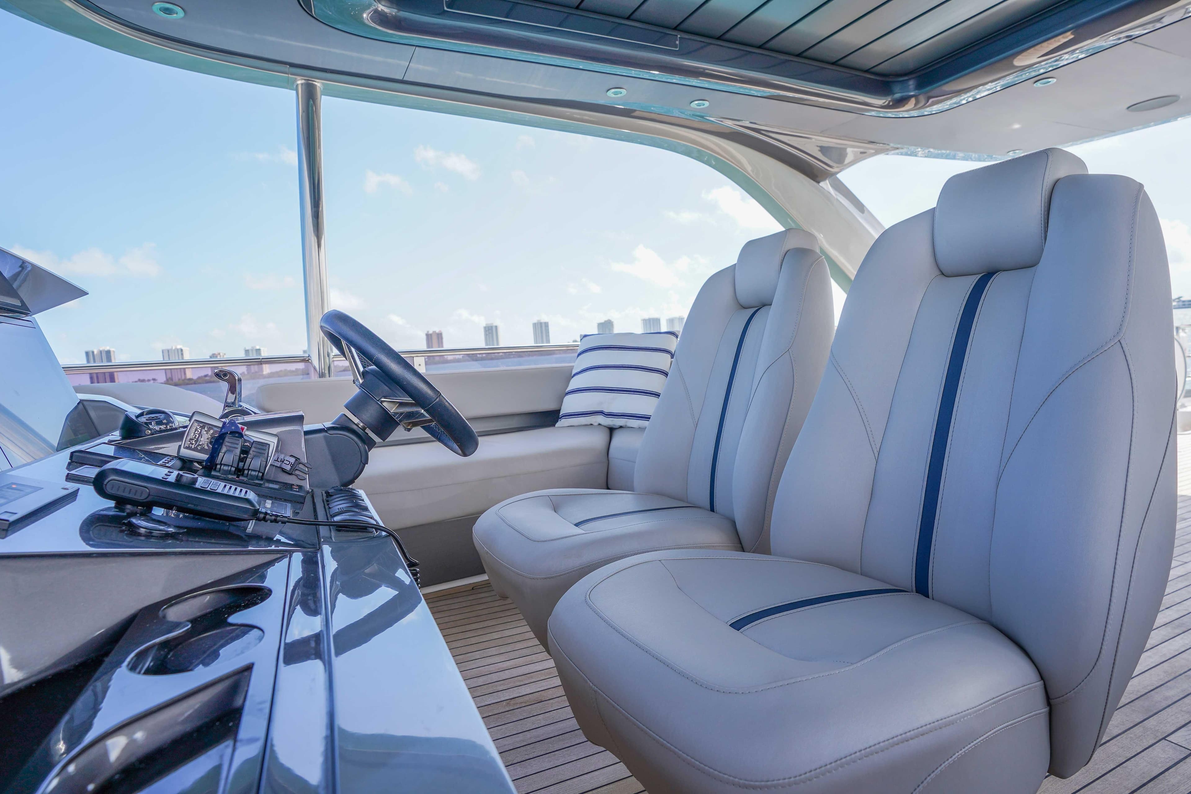 Luxurious interior of 2021 Princess Y85 yacht with plush seating and modern controls.