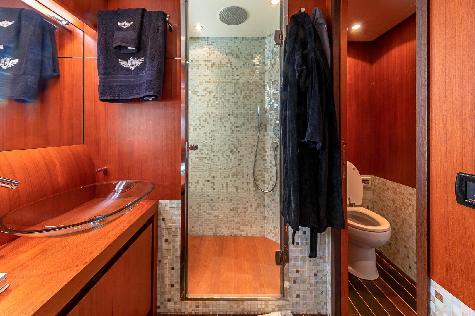 Luxurious bathroom on 2008 Pershing 90 yacht with glass sink and modern shower.