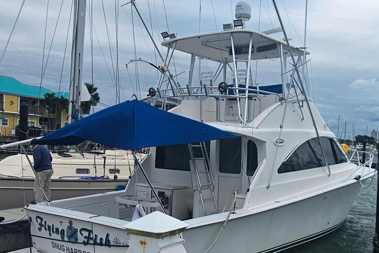 2000 Ocean Yachts 40 Super Sport docked, featuring a blue canopy and sleek design.