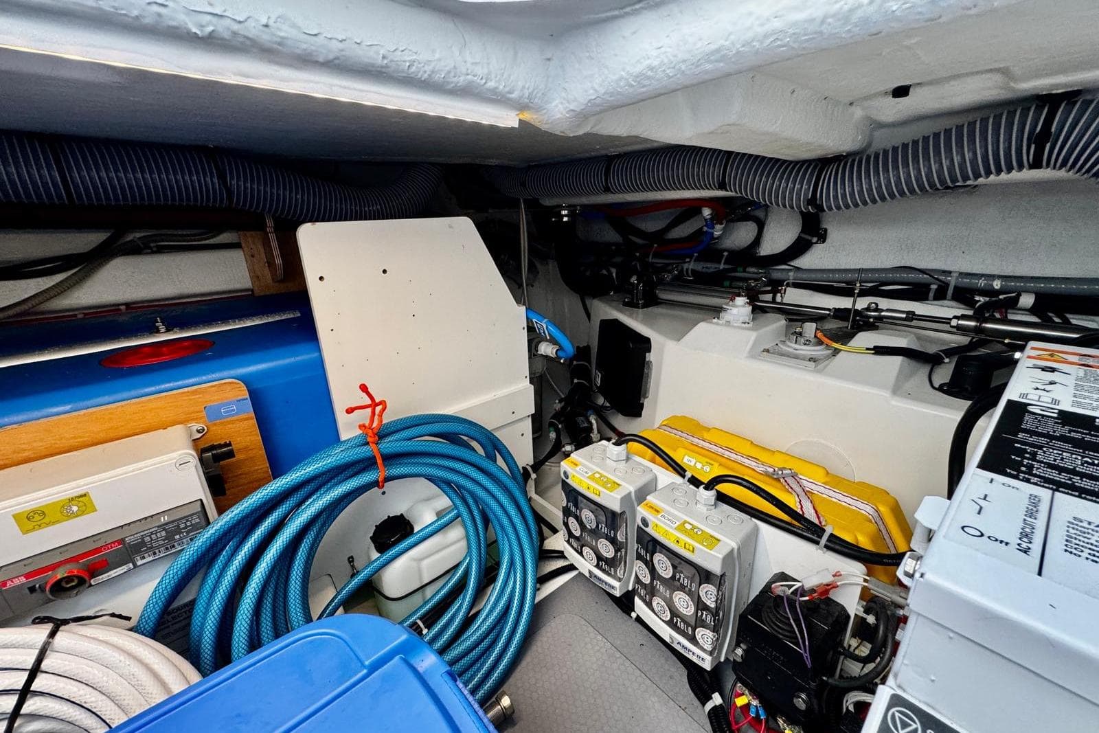 Engine room of 2022 Beneteau Swift Trawler 41 Fly with cables and equipment.