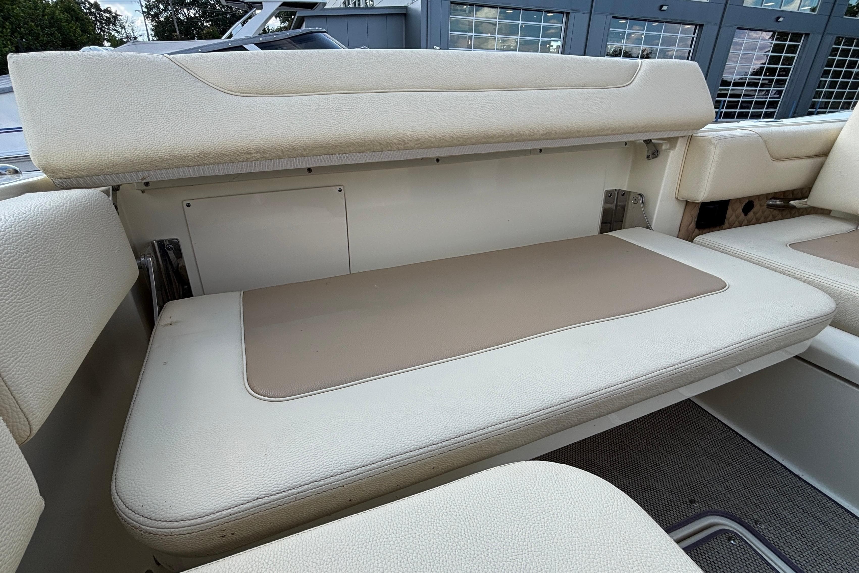 2021 Chris-Craft Calypso 35 boat interior seating with beige and cream upholstery.