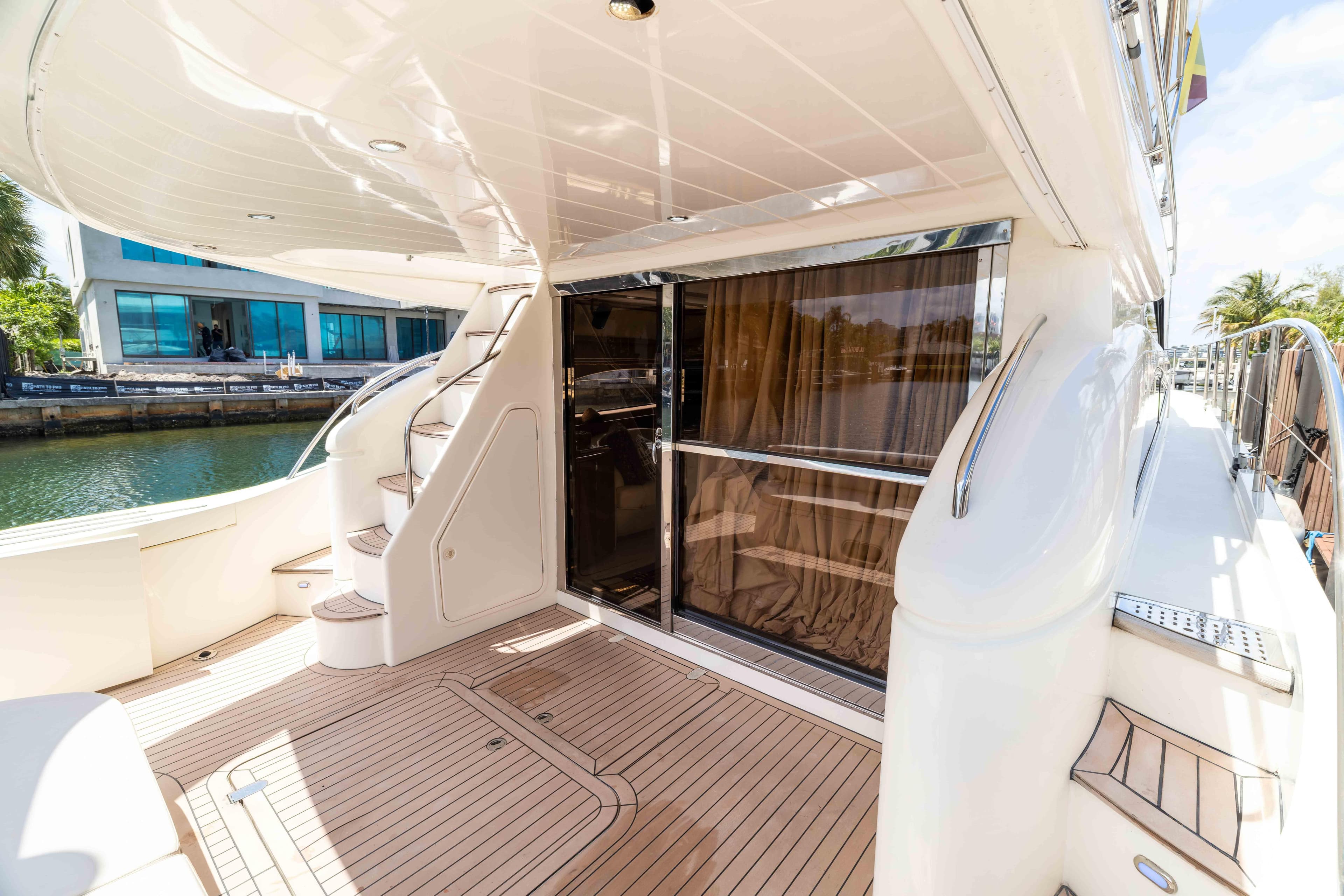 Luxurious 2002 Princess 61 yacht deck with elegant wood flooring and sleek design.