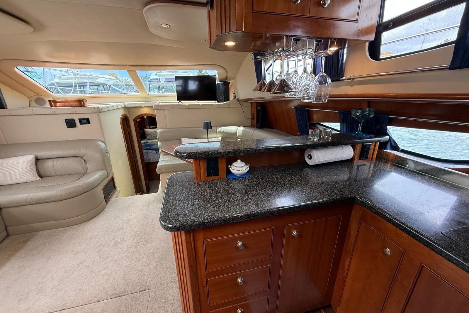 Luxurious interior of 2005 Cruisers Yachts 455 Express Motoryacht with elegant wood cabinetry.