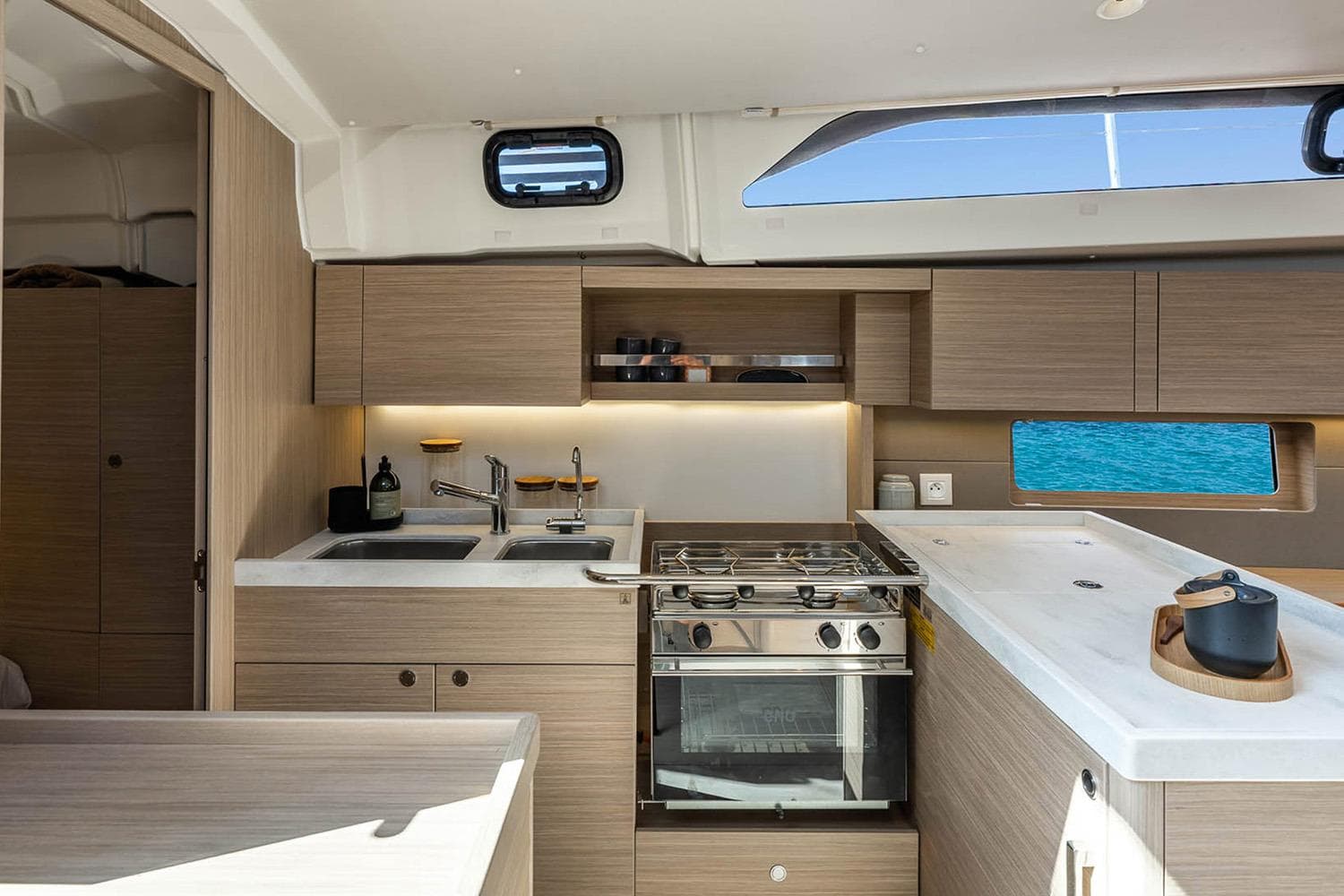 Manufacturer Provided Image: Modern kitchen interior of 2026 Beneteau Oceanis 47 yacht with ocean view.