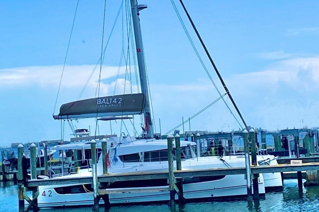 2023 Bali 4.2 catamaran docked at a marina under a clear blue sky.