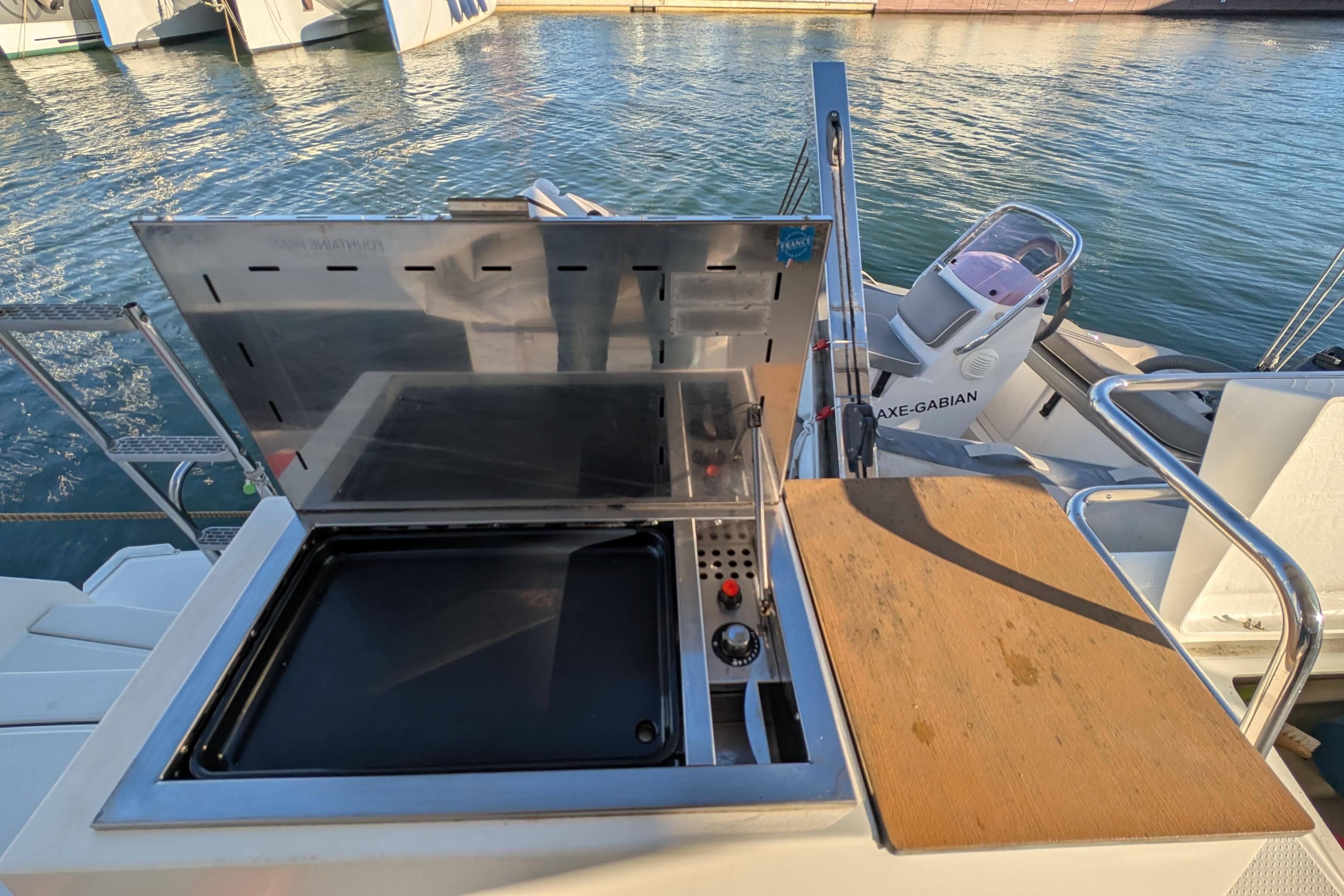 Outdoor grill on 2020 Fountaine Pajot Astrea 42 Catamaran, docked by the water.