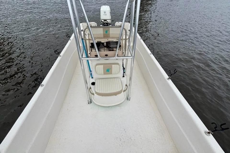 2017 Carolina Skiff 238 DLV boat on water, featuring center console and seating.