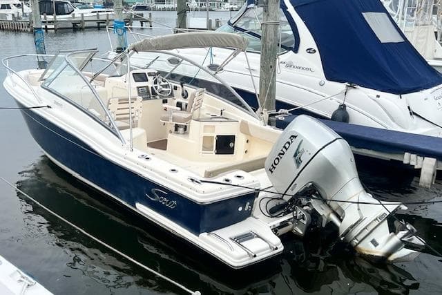 2008 Scout 242 Dorado boat with Honda outboard motor docked at marina.