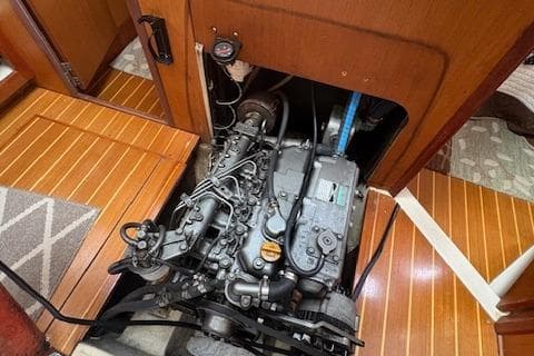 Engine compartment of a 1999 Hunter 410 sailboat, showcasing detailed mechanical components.