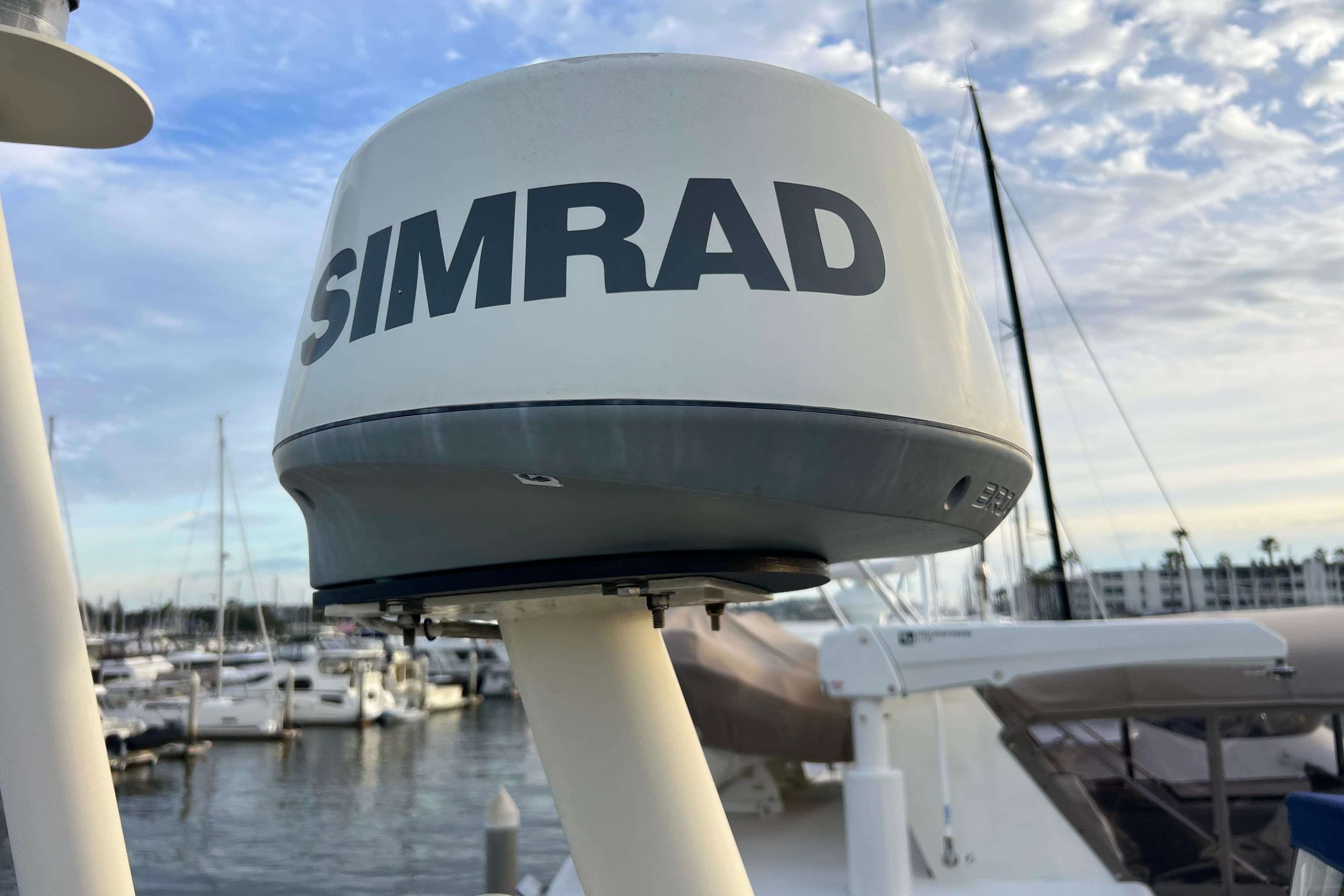 Simrad radar on 1985 Tollycraft 48 Cockpit Motor Yacht, docked in marina.