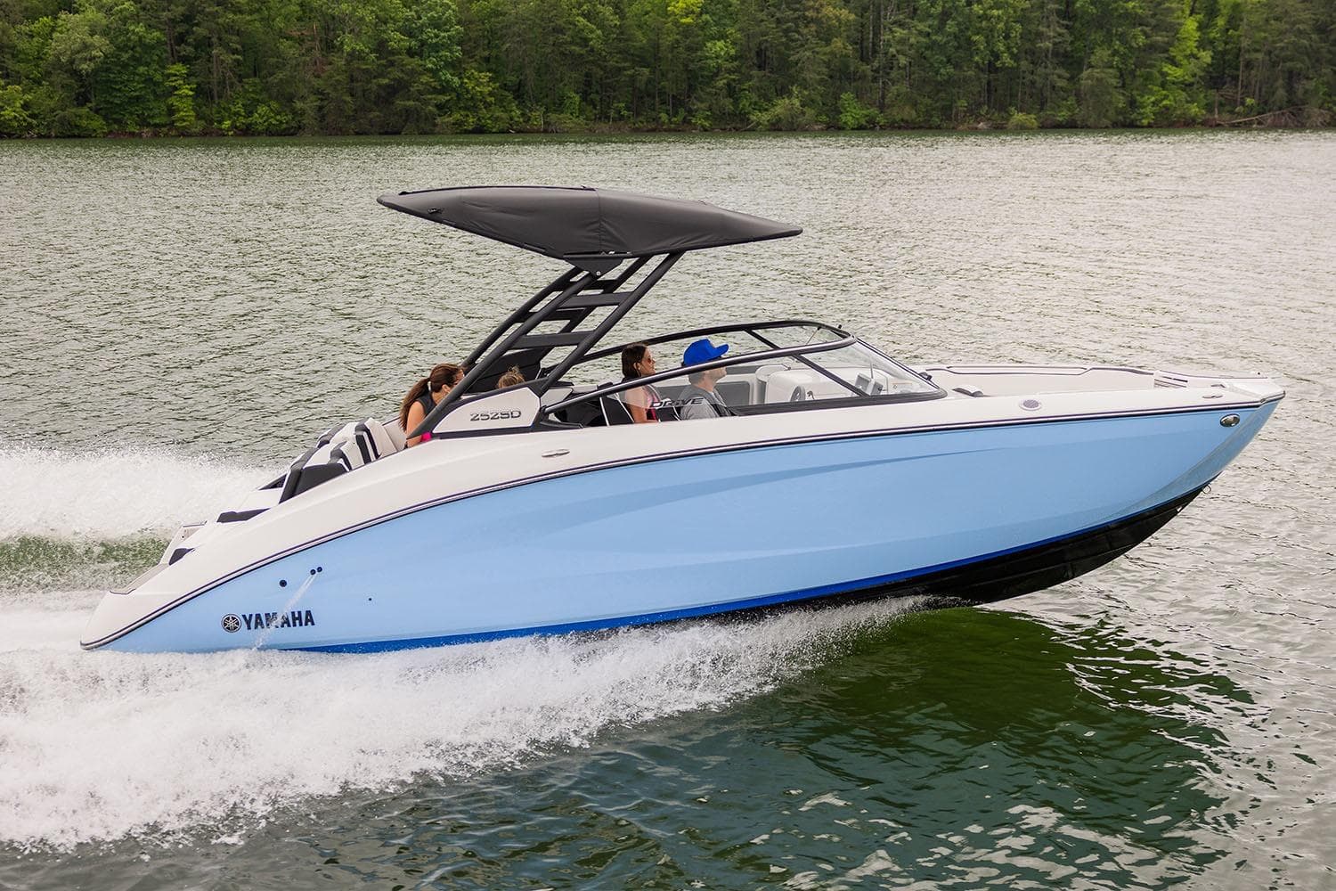 Manufacturer Provided Image: 2026 Yamaha Boats 252SD cruising on a lake with passengers, surrounded by lush greenery.