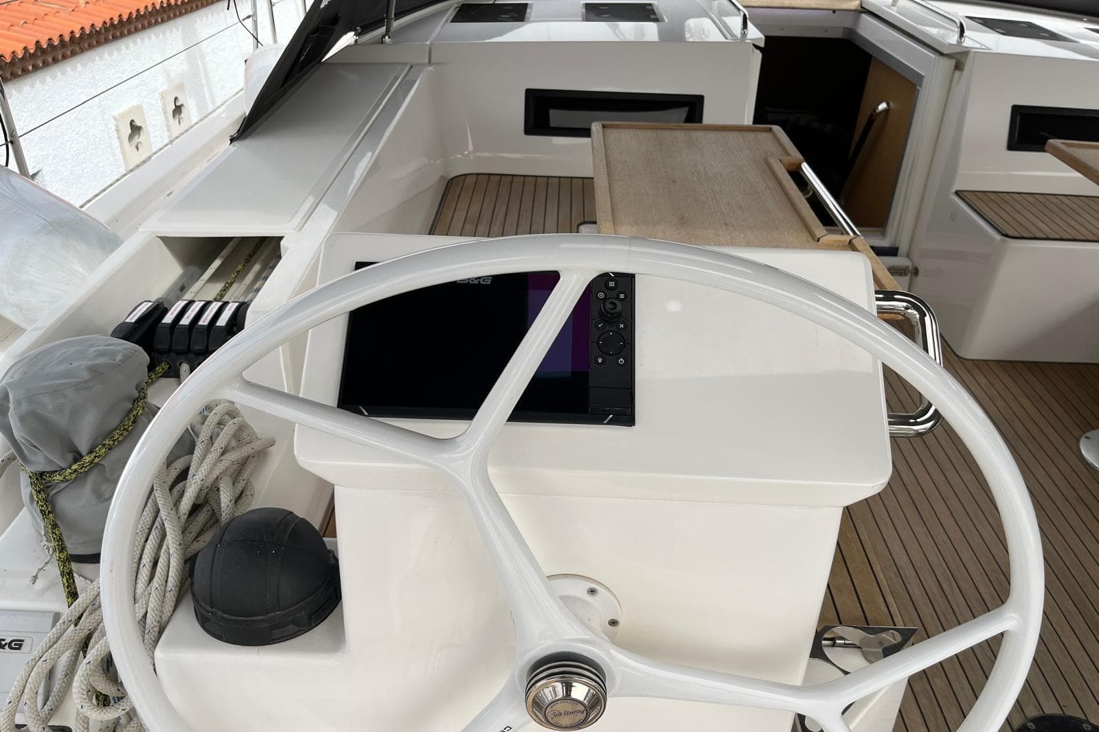 Steering wheel of a 2022 Bavaria C50 yacht with navigation equipment.