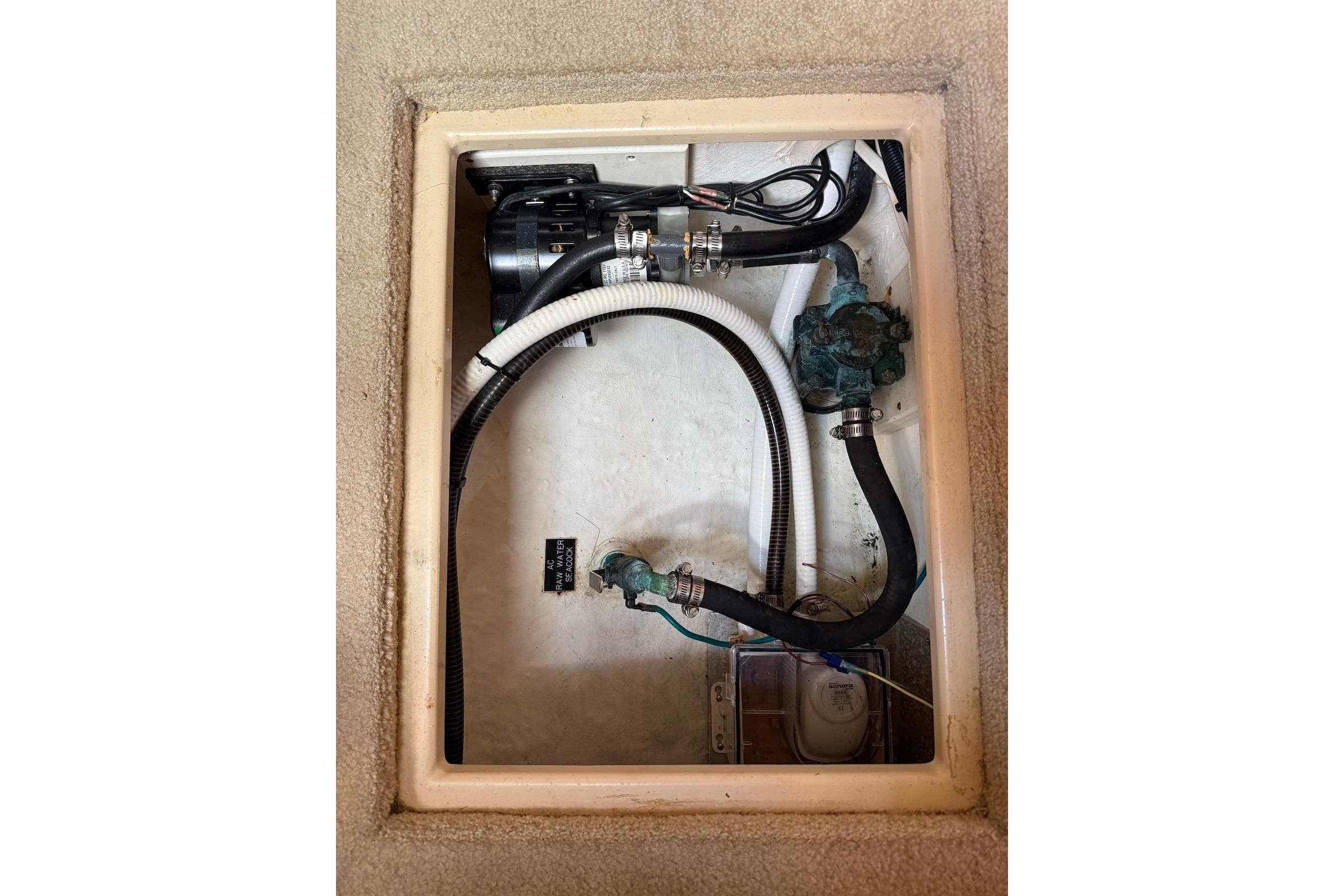 Bilge compartment of 2007 Cruisers Yachts 420 Express with hoses and pump system.