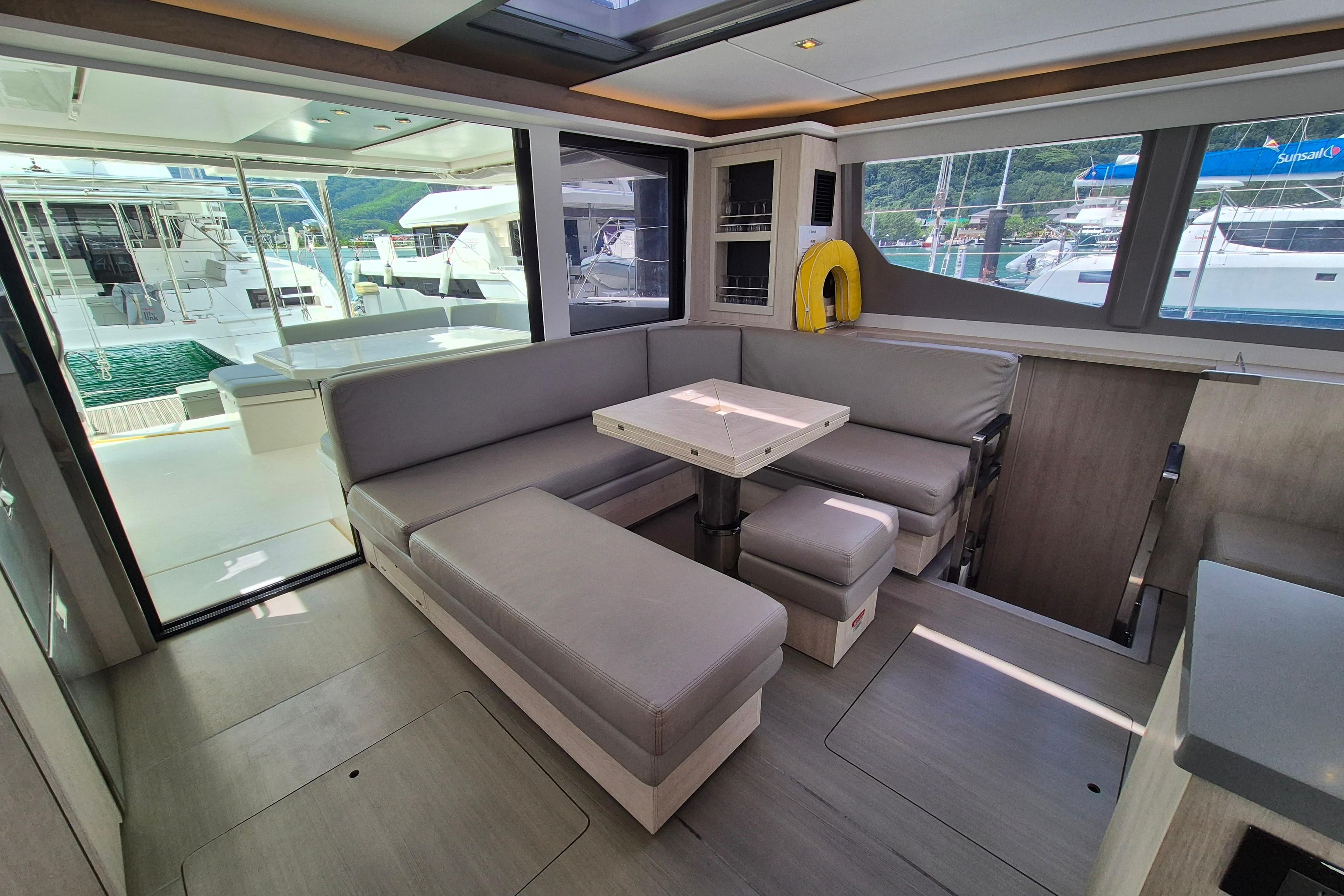 Modern interior of 2021 Leopard 45 yacht with spacious seating and large windows.