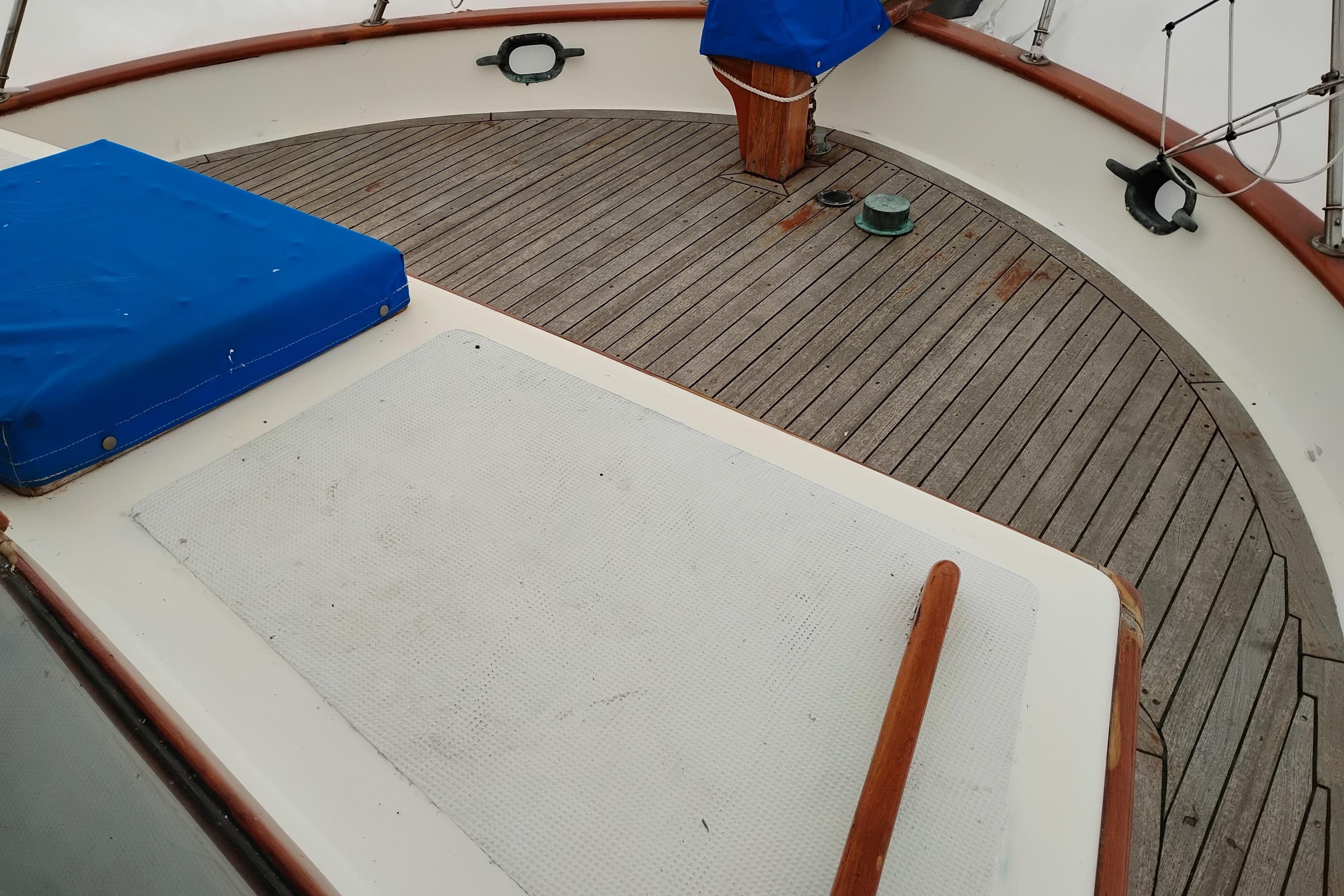 1979 Transpac Eagle 36 Trawler deck with wooden finish and blue covers.