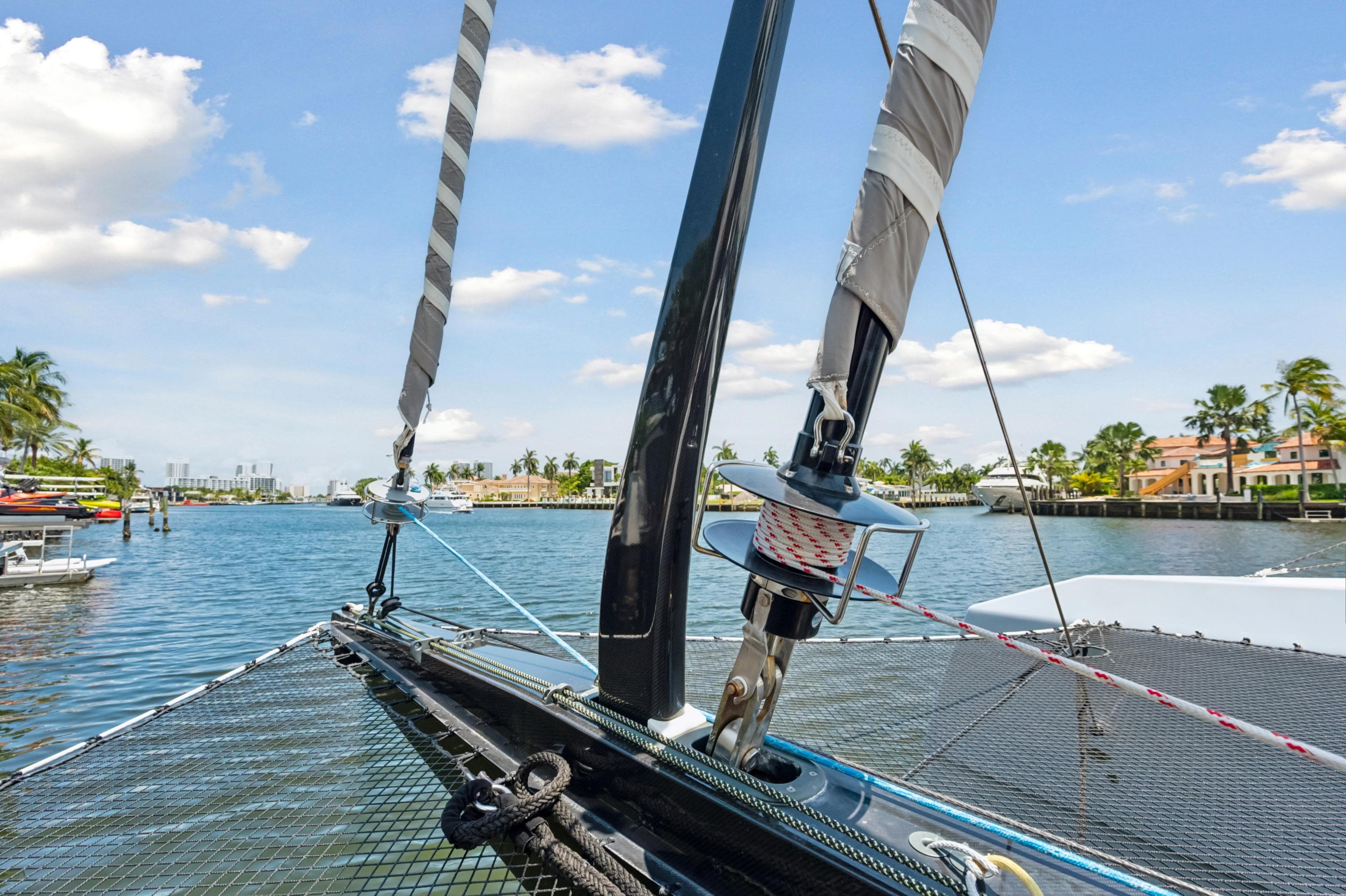 2019 McConaghy MC60 sailboat on a sunny waterfront, showcasing rigging and netting.